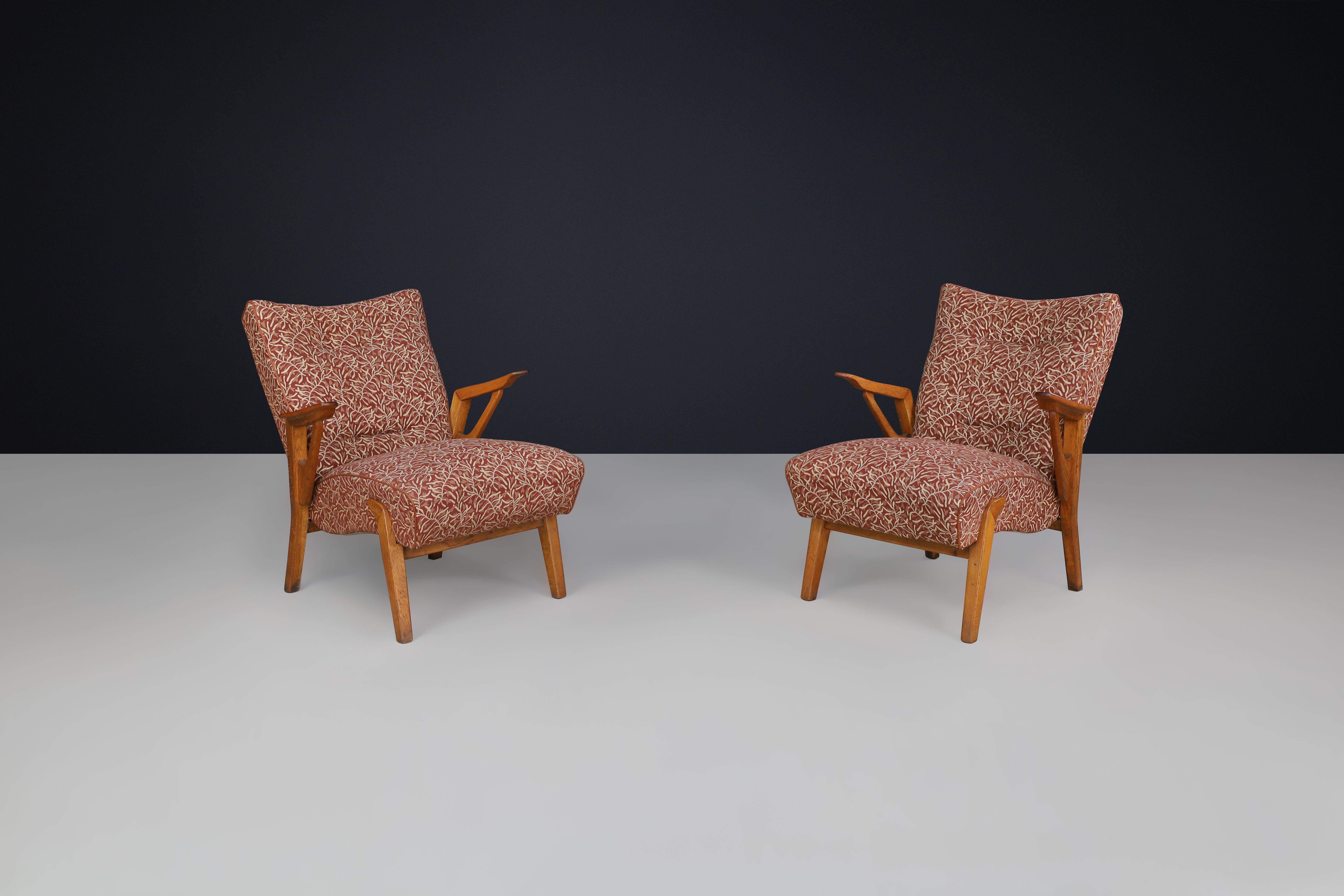 Art Deco lounge chairs in Oak and Original Upholstery By Antonin Kybal, CZ 1930s

We are excited to share a great example of Art Deco design with you.—a set of two oak armchairs attributed to Czech textile designer Antonín Kybal. Crafted in the