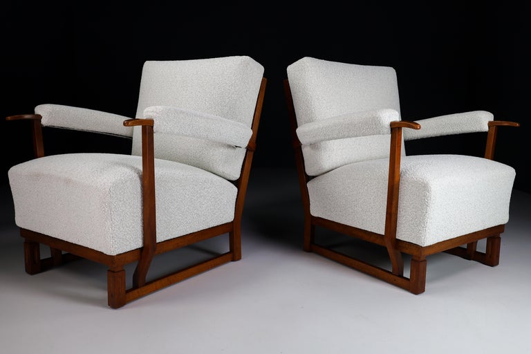 Large size Art Deco lounge chairs manufactured and designed in France 1940s. Made of french oak and these lounge chair has just been reupholstered with Bouclé wool fabric. It is in perfect condition, minor patina on wood parts. These amazing lounge