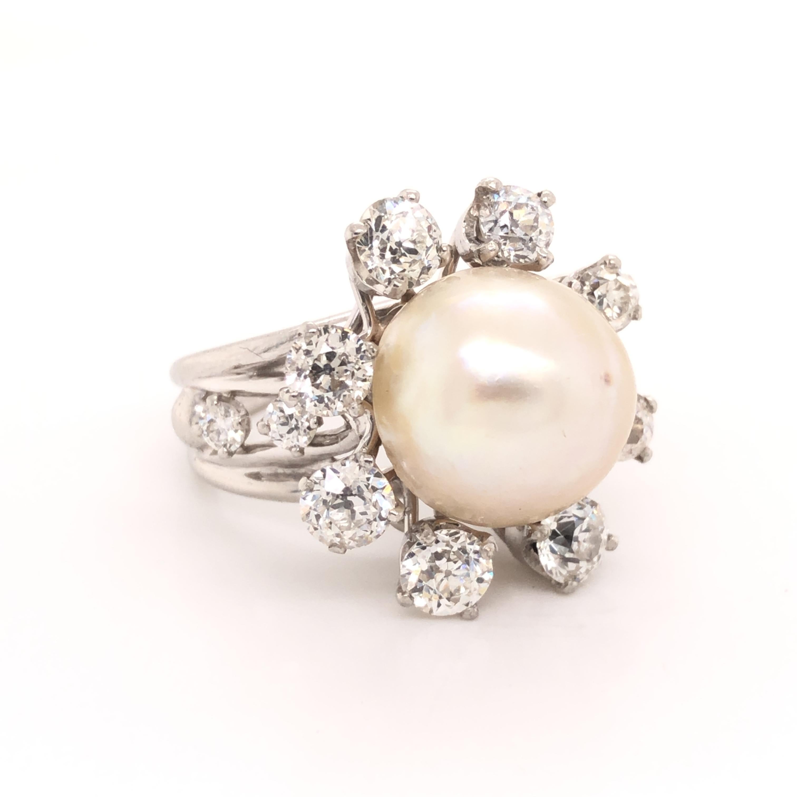 Timeless design on this beautiful ring. The focal point of the ring is one saltwater pearl gemstone that has exceptional luster and irradescense and baroque in shape. The pearl is adorned with old mine cut natural earth mined diamonds that are