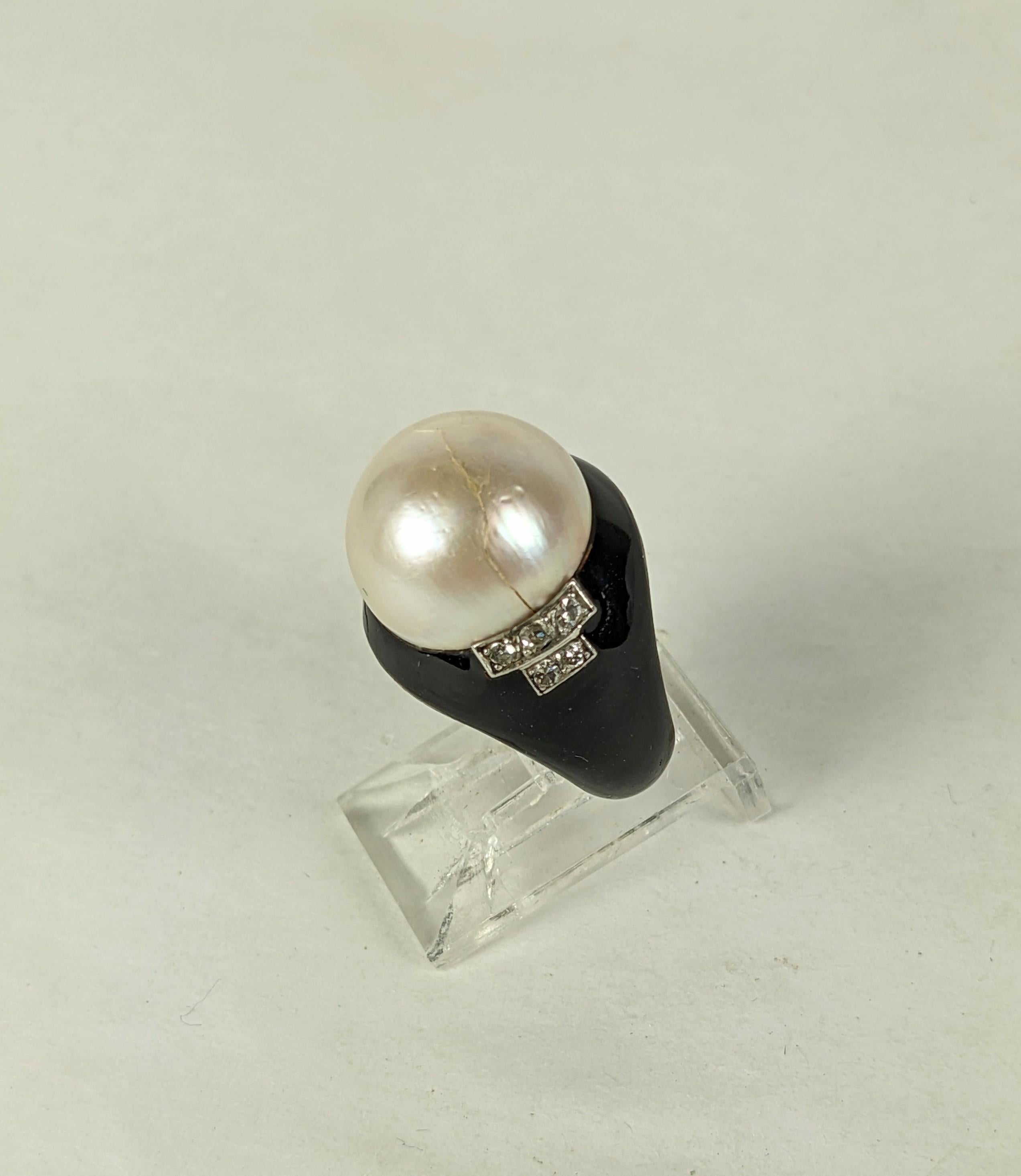 Lovely Art Deco Mabe Pearl, Enamel and Diamond Ring, Attributed to Rene Boivin from the 1920's. Set in silver with a large domed mabe pearl and stepped design on diamonds running down the shoulders on a base of black enamel. Unsigned. 1920's France. 