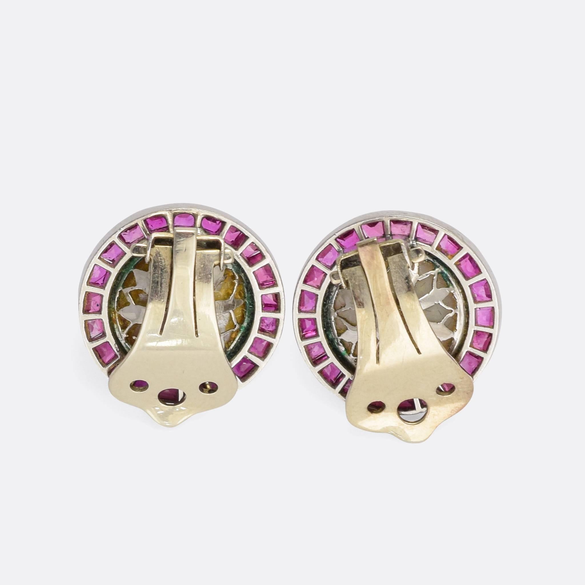 A spectacular pair of vintage clip-on earrings, each one set with a mabe pearl within a halo of calibré cut rubies. The stones are set in platinum, the rubies are bright and vibrant, and the pearls display excellent coloured lustre. A stunning pair