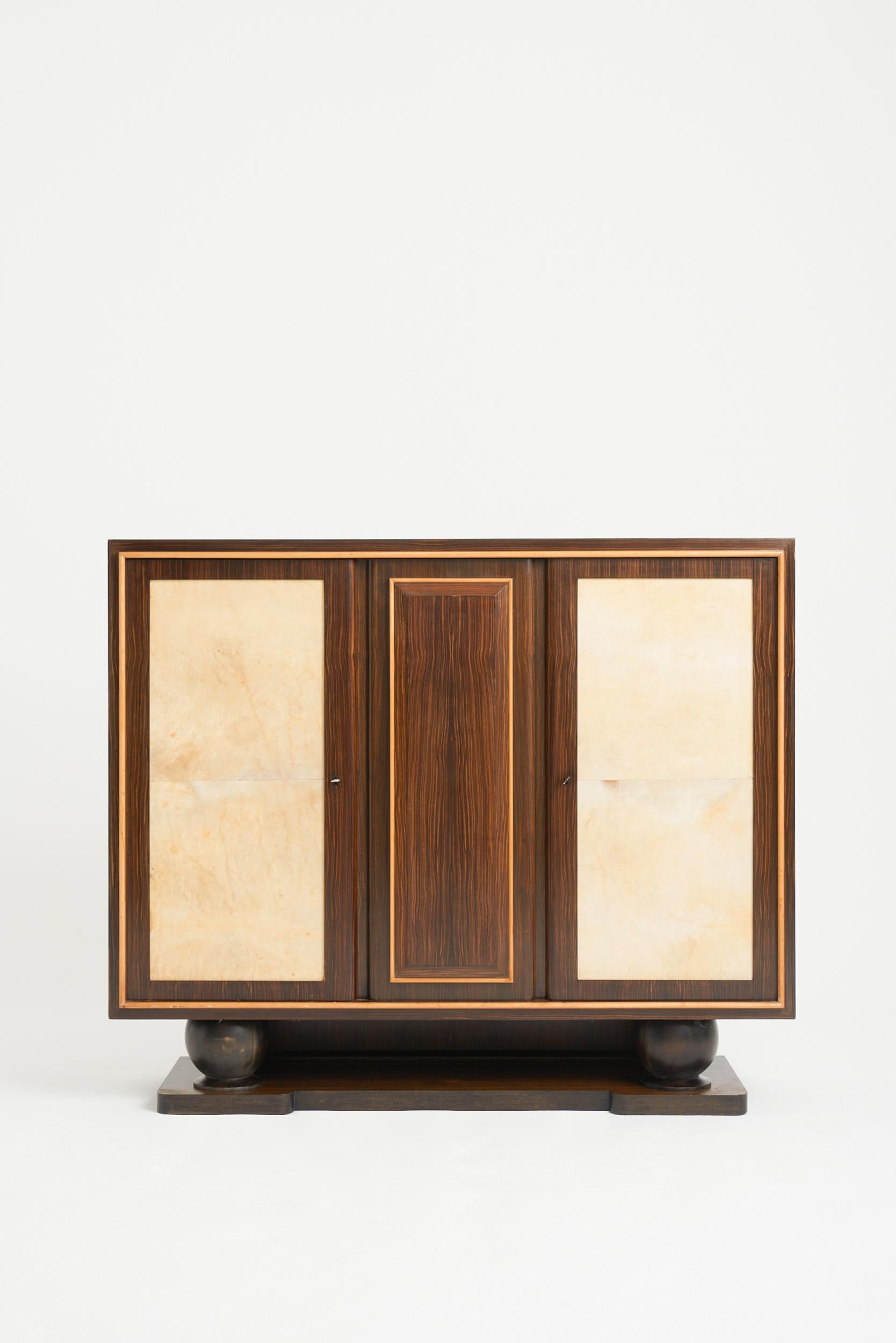 An Art Deco macassar ebony and velum cabinet
France, 1940s.
126 cm high by 150 cm wide by 44 cm depth