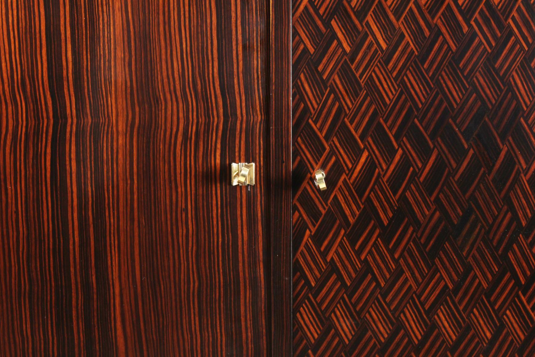 Art Deco Macassar ebony sideboard, circa 1930
A French Art Deco sideboard in Macassar Ebony and Piano lacquer finish with inset glass top three locking doors and shelf behind, the sideboard has been fully polished with a high gloss finish

Age: