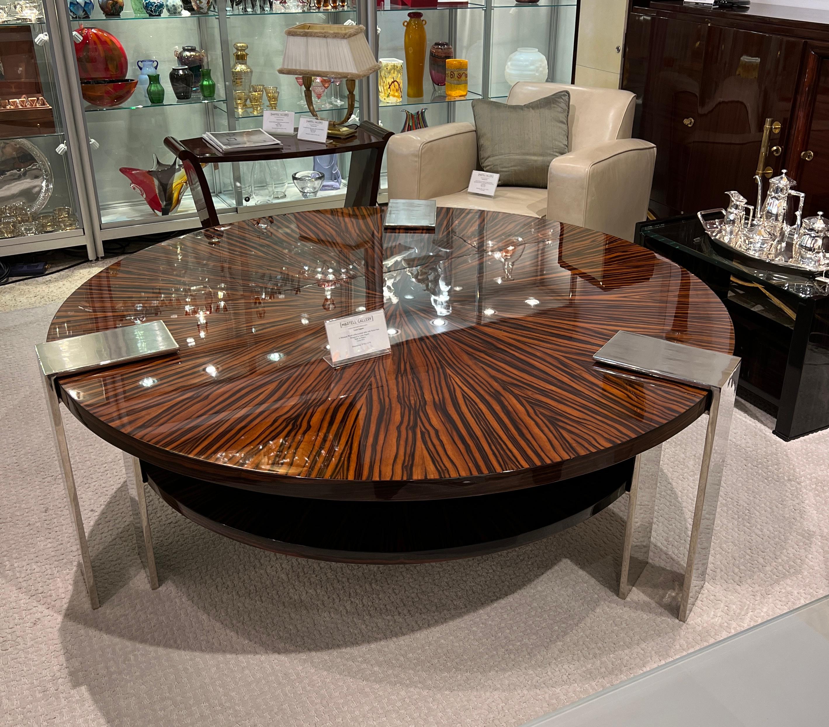 A round coffee/cocktail table with a Soleil Marquetry in Makassar Ebony Wood with a geometric Nickel base.  This table was Made in France in 1935.

Louis Sognot was a French designer and architect who was active during the Art Deco period. During