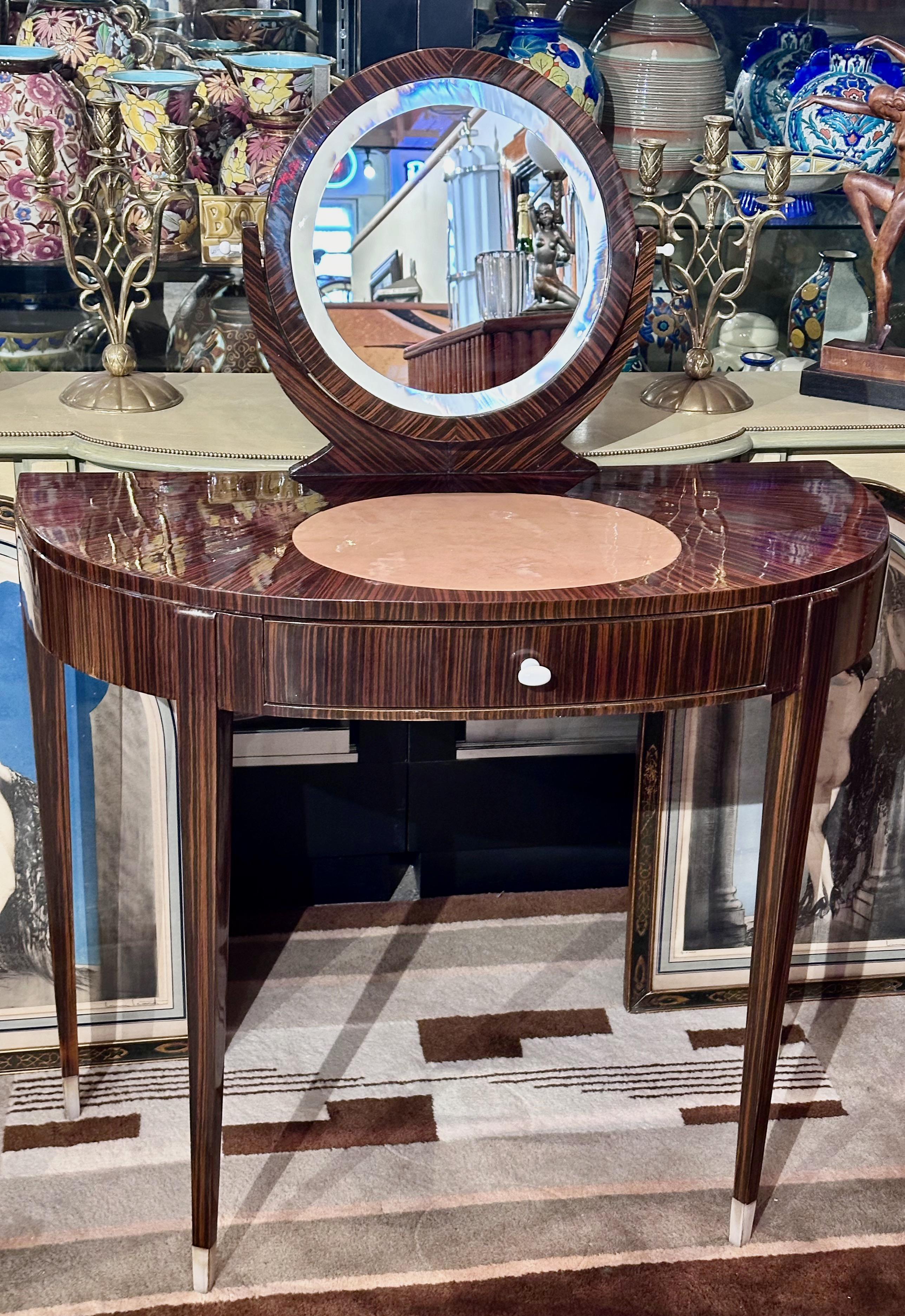 A vanity cabinet in the Ruhlmann style would likely exhibit these characteristics, with a focus on craftsmanship, geometric forms, and luxurious materials such as Macassar ebony. It features sleek lines, symmetrical patterns, and intricate inlay,