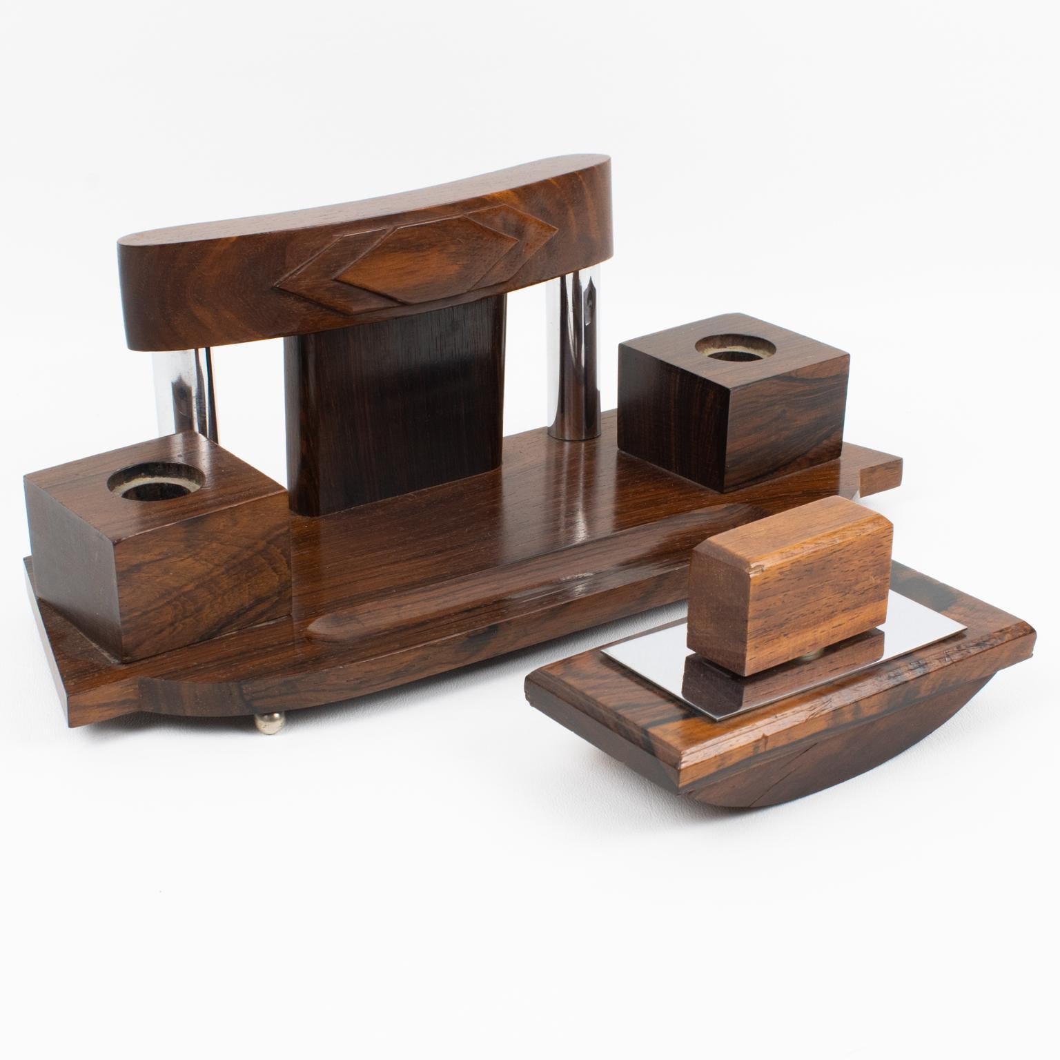 This gorgeous Art Deco modernist desk accessory set was produced in France in the 1930s. The set is built with a double inkwell and a matching blotter. The sleek geometric shape has carved and shaped Macassar wood main body and chromed metal