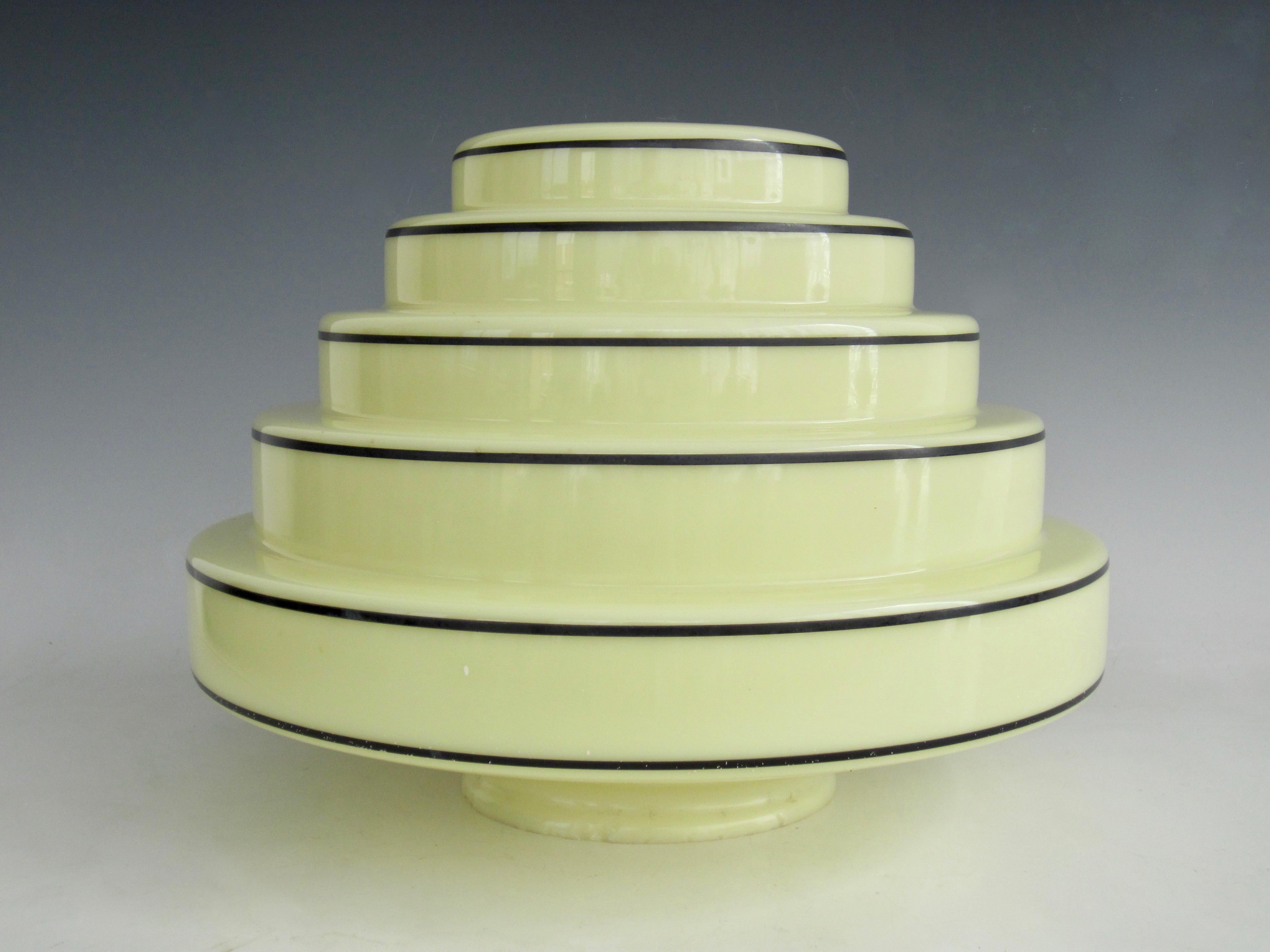 An Art Deco period Macbeth-Evans Glass Company stepped custard glass globe with black pin striping. Will work as a flush or semi-flush mount. Good condition.
