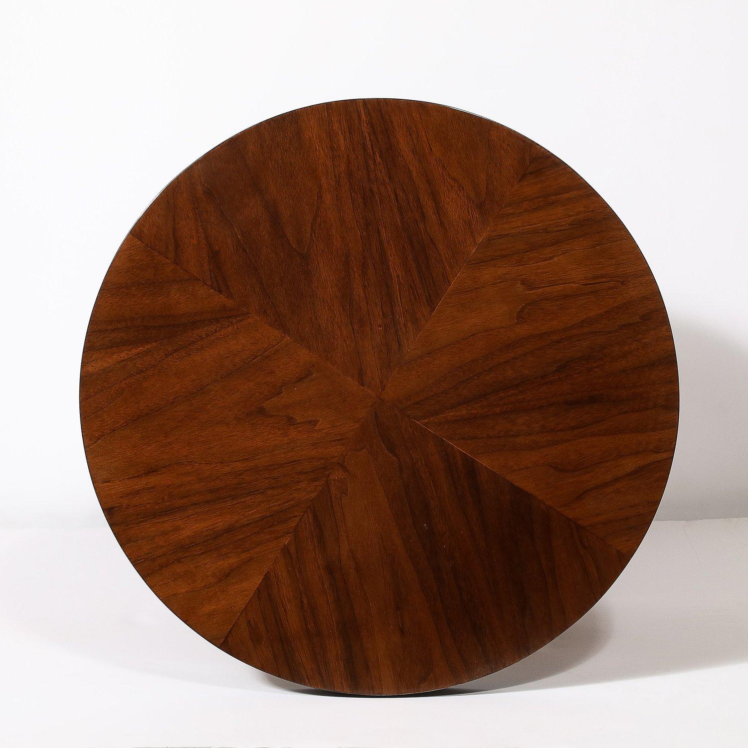 This versatile and materially exquisite Art Deco Machine Age Three-Tier Round Side Table in Book-Matched Walnut & Black Lacquer originates from the United States, Circa 1935. Well scaled and with beautiful proportions, this table serves as an