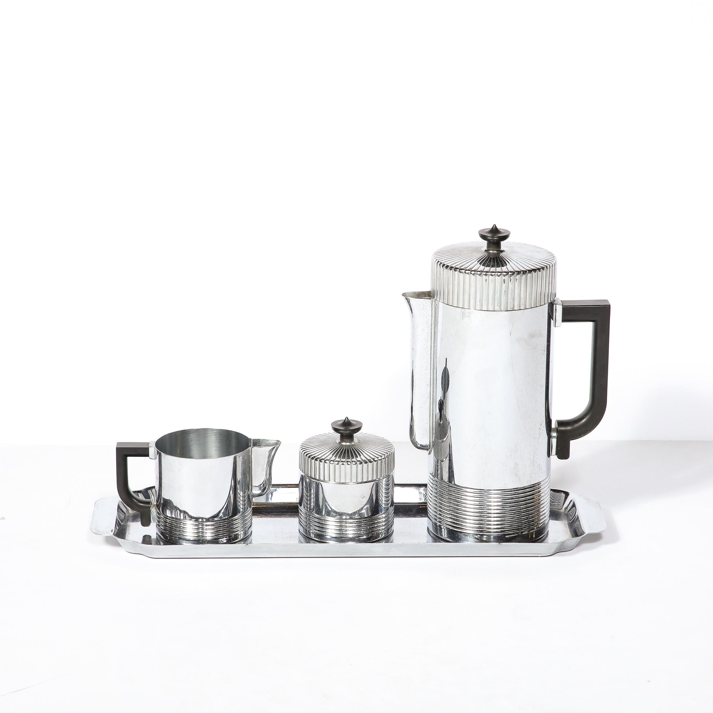 Excellent example of Streamline Art Deco design, this coffee service was manufactured by Chase in the United States circa 1930. Composed of four pieces - a coffee maker with percolator function and cream pot, a sugar vessel, and a serving tray –
