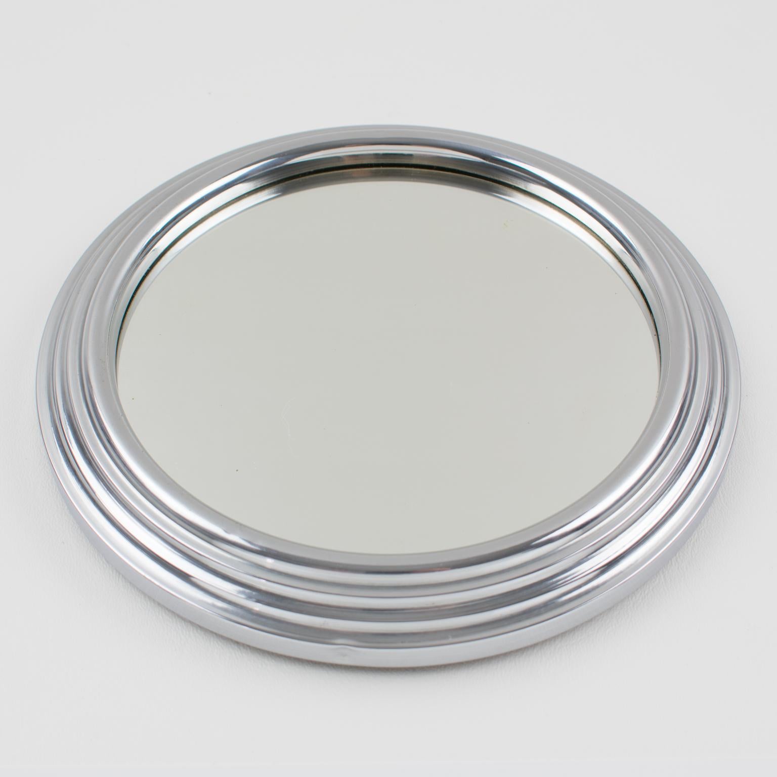 Modernist French cocktail serving tray. Machine Age industrial design with chromed metal round stepped shape and mirror insert.
Measurements: 7.88 in. diameter (20 cm) x 1 in. high (2.5 cm), insert diameter is 6.13 in. (15.5 cm).