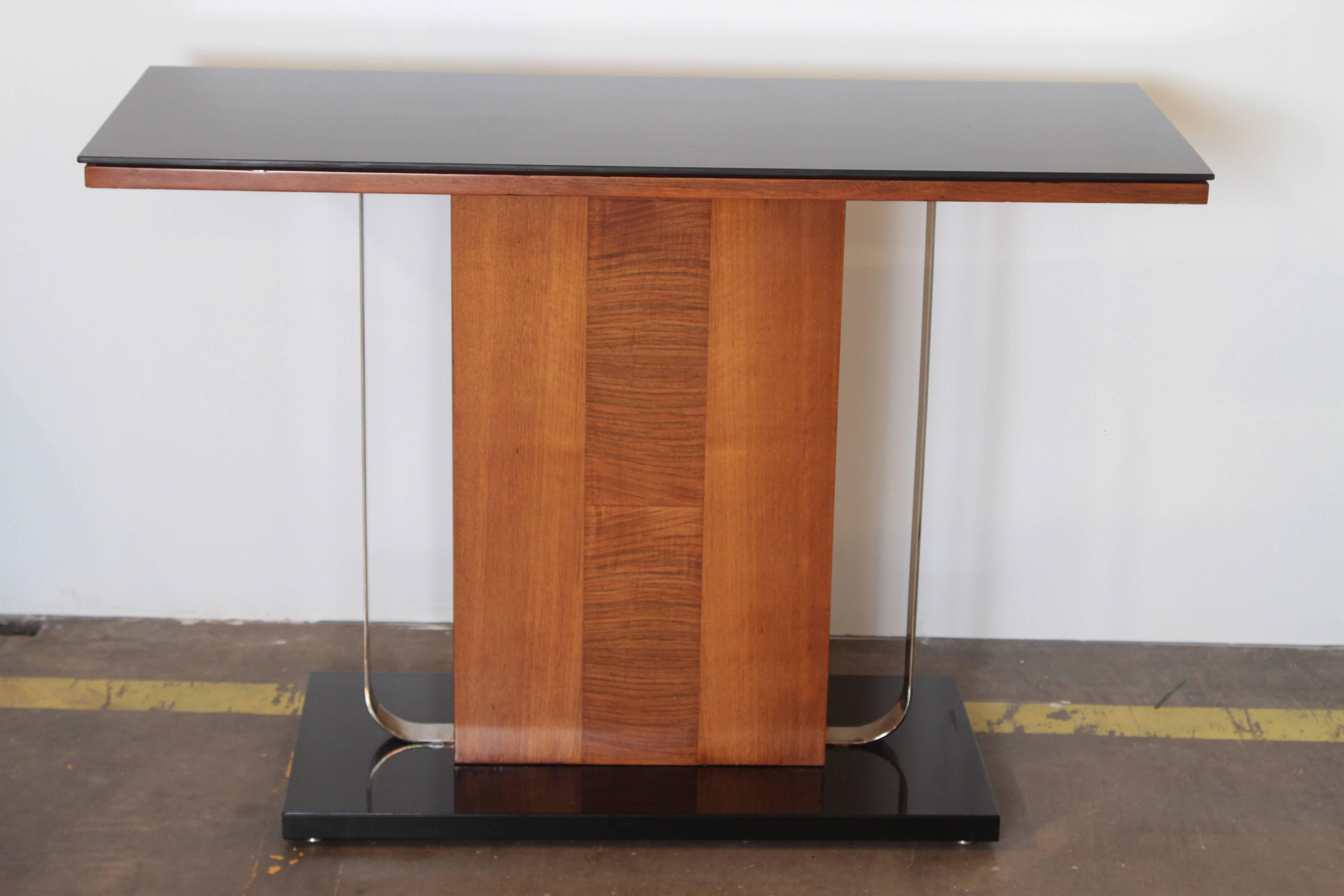 Art Deco Machine Age Console / Entry / Sofa Table Chrome Vitrolite Bakelite Burl

Attractive mixed - media combination of exotic wood, vitrolite glass top, chromed flat bands and lacquered base.
Very good original condition, base possibly re
