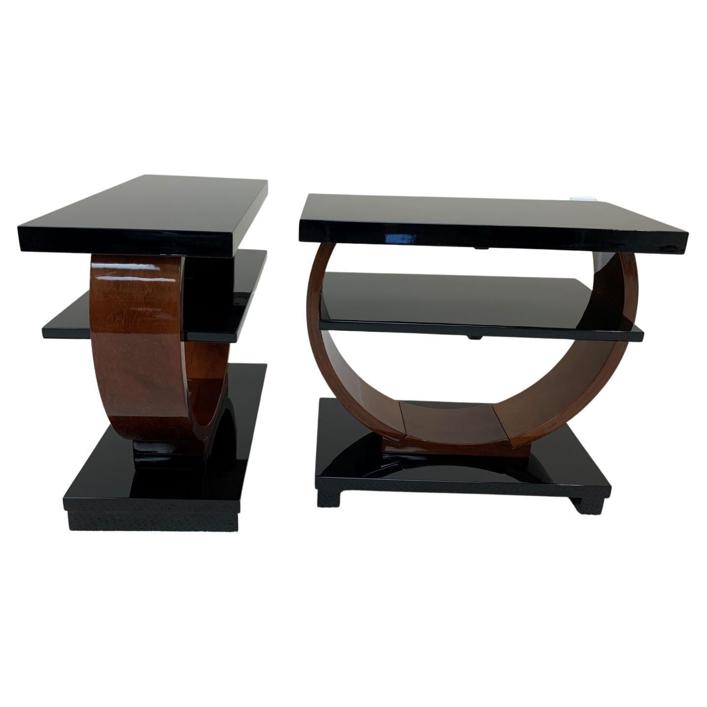 This stunning pair of Art Deco Machine Age tables were retailed by The Modernage Furniture Company in the 1930’s and 1940’s. It features an elegant circular design that supports a rectangular base, shelf and top. This piece is sure to delight