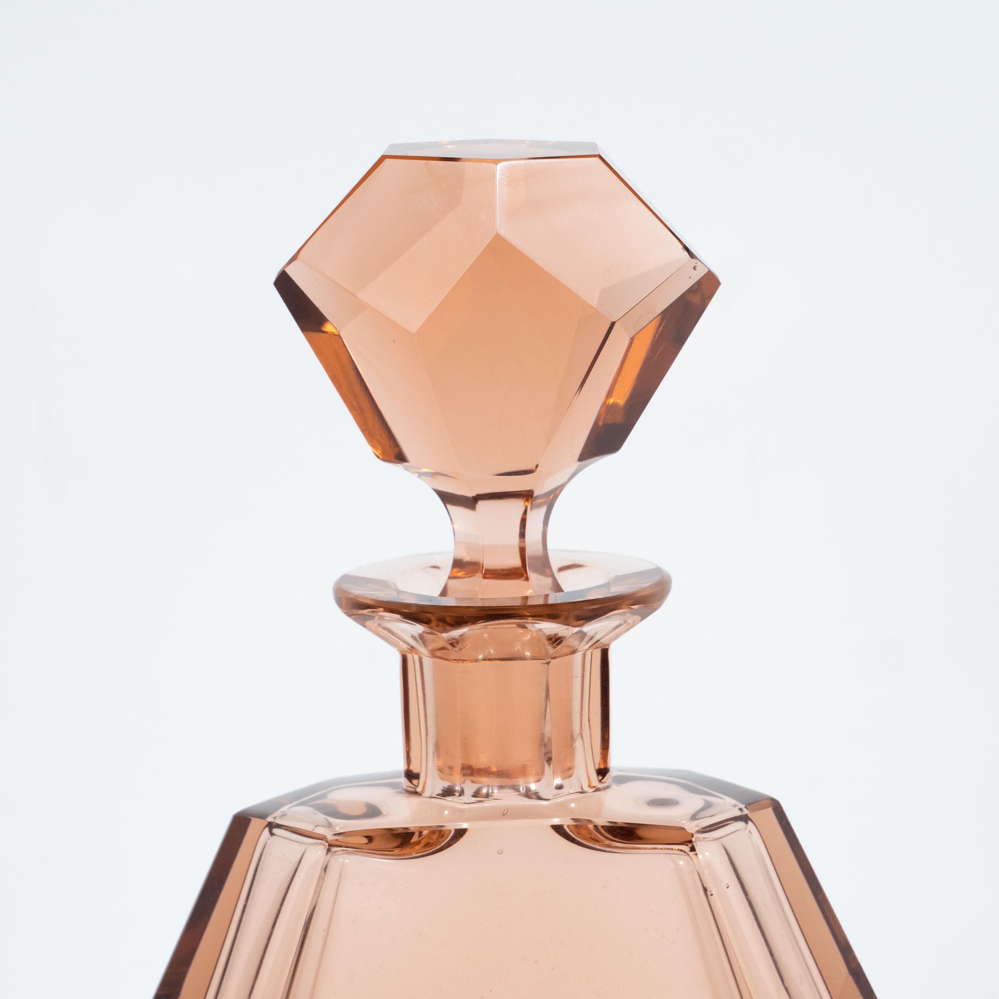 This gorgeous Art Deco Machine Age decanter was realized in the Czech Republic- a country renowned for the period for its superlative glass products, circa 1930. It features a faceted body replete with dynamic angles and geometric forms realized in
