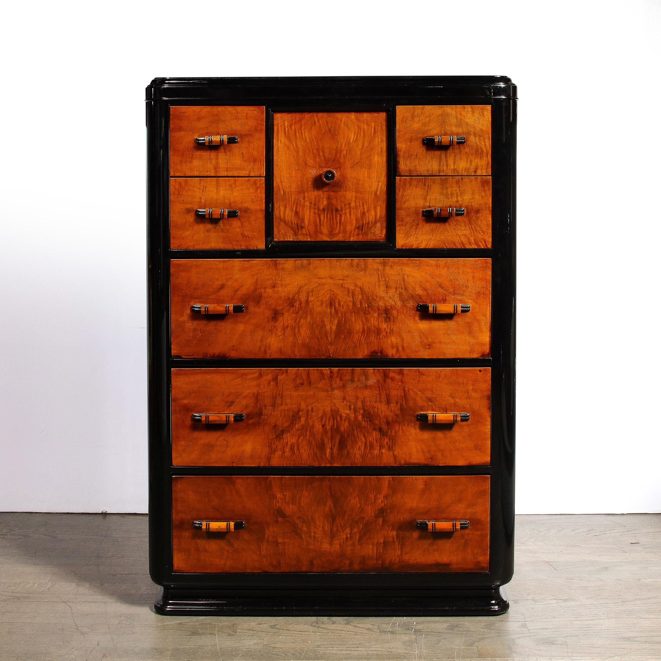 This elegant and sophisticated Machine Age Art Deco high chest was realized in France circa 1935. It features a lustrous black lacquer base and body with three lower drawers, two pairs of top drawers, and a central compartment (with original