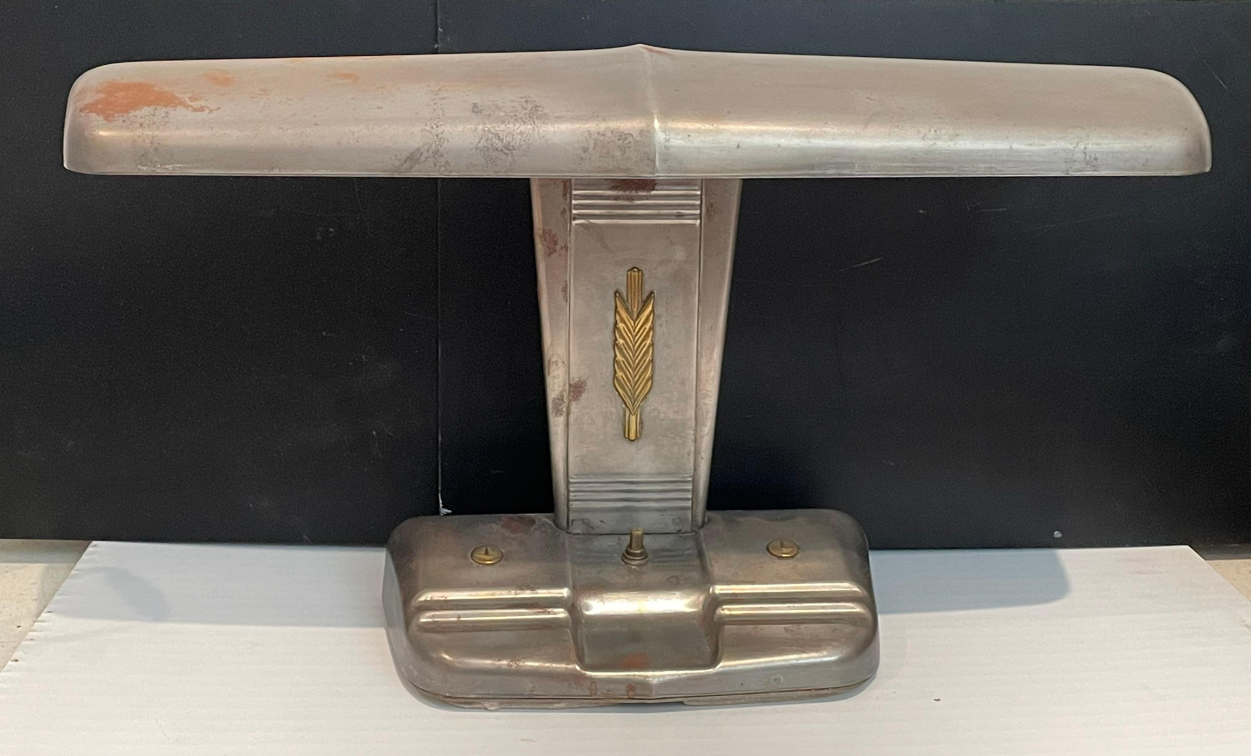 A very cool airplane tail desk lamp this lamp has been stripped and left in the original metal finish with some patina due to age, great brass accents with push-off/on switch. and in perfect working condition.