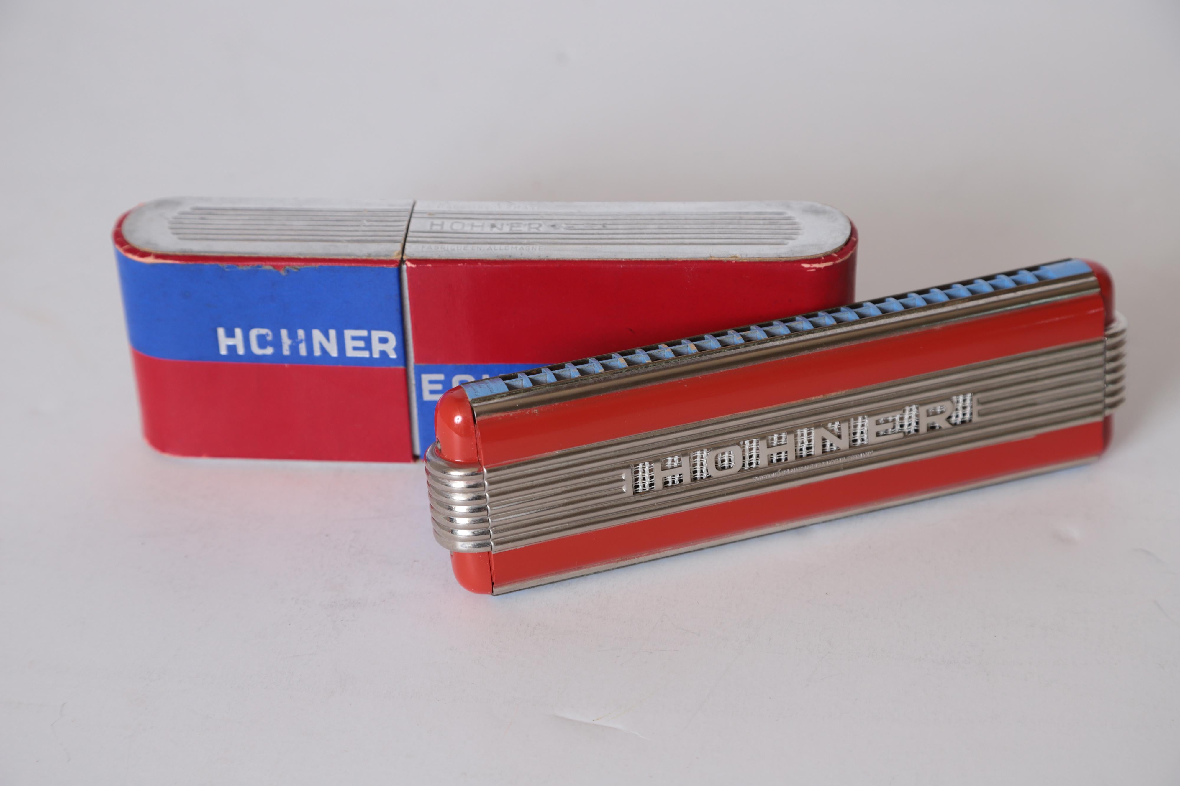 Art Deco Machine Age John Vassos streamline Harmonica for Hohner, circa 1936

Near Mint, in original box.
These are very cool. Great Vassos original patented design.

The red and chrome Echo Elite harmonica was made in three sizes and in