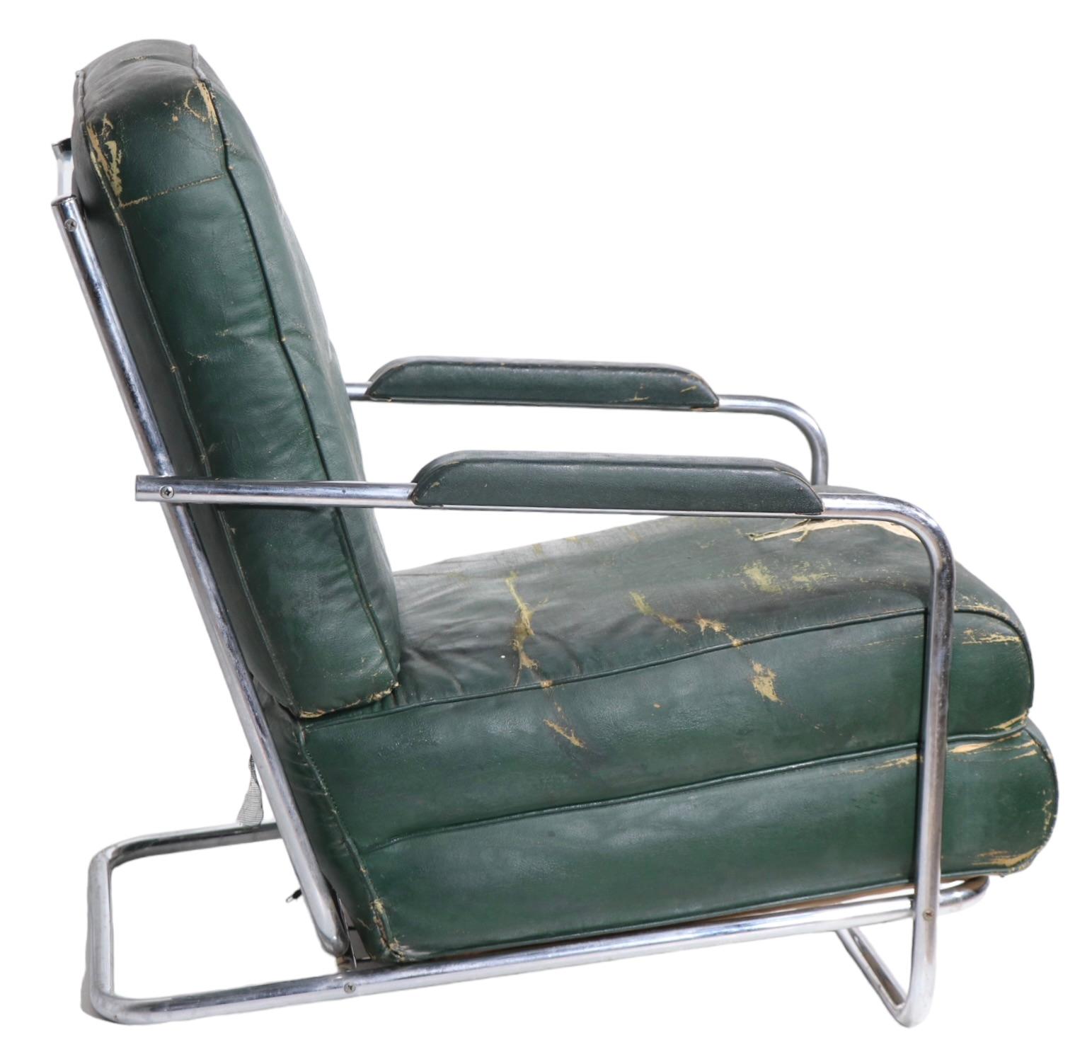 Iconic Art Deco, Machine Age lounge chair designed by Gilbert Rohde for the Troy Sunshade Company circa 1930's. The chair features a sexy tubular chrome frame with large upholstered cushions,  the original oil cloth fabric  shows significant wear,