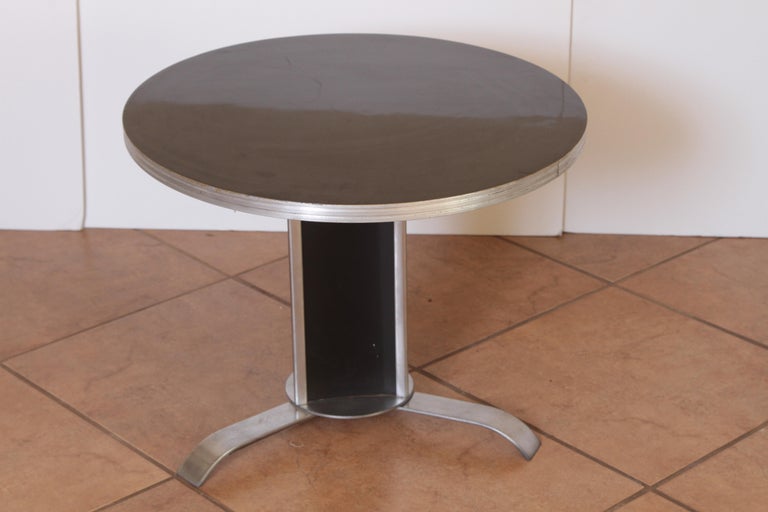 Art Deco machine age McKay craft occasional cocktail coffee side table McKay craft chrome black lacquer.

Rare original McKay table design. Very difficult to source style.
Satin chromed steel triangular flat-band base, with lacquered triangular
