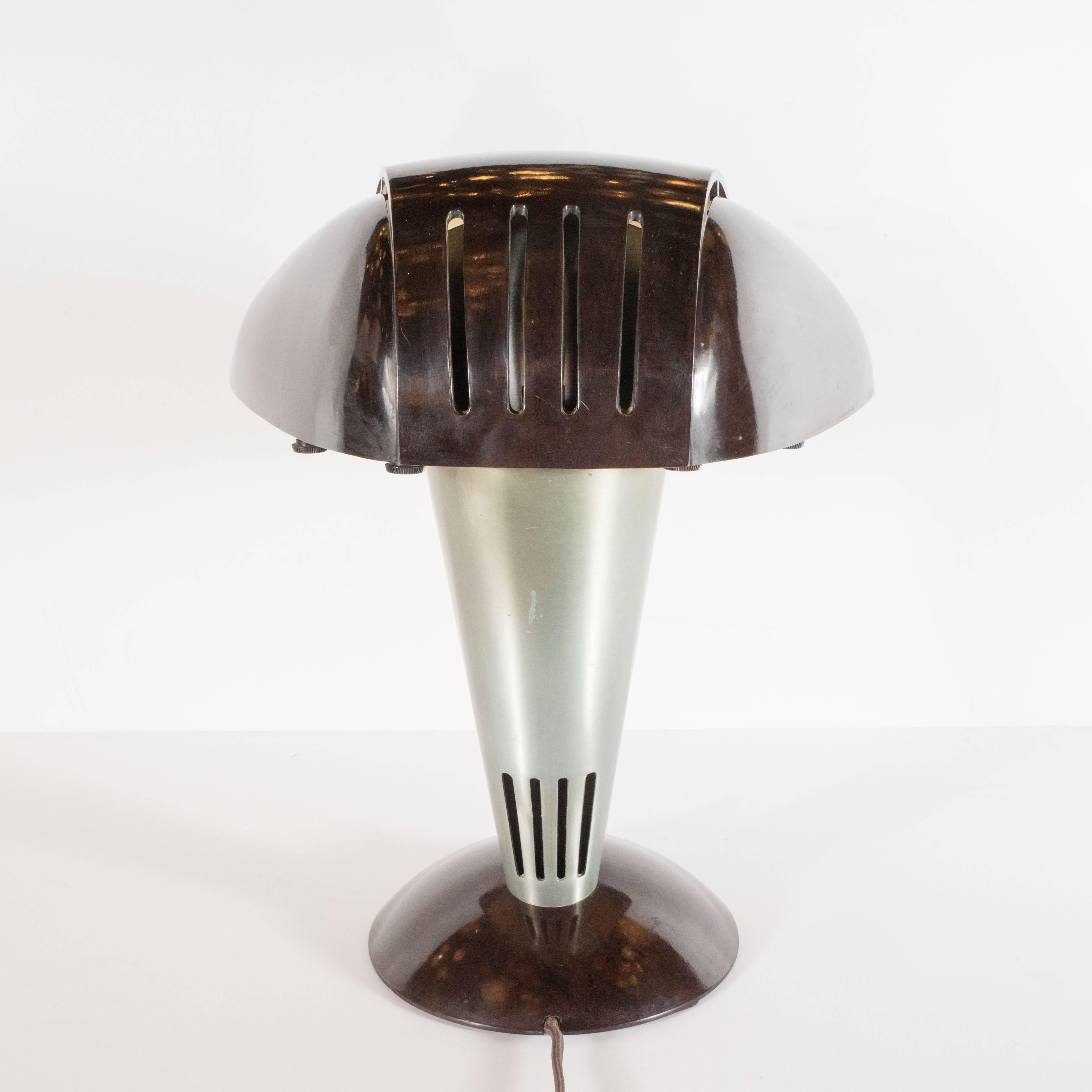 This graphic and iconic desk lamp was realized by the esteemed American designer Walter Dorwin Teague in America, circa 1939. It represents one of Teague's most important and celebrated designs. The lamp features a streamlined domed skyscraper style