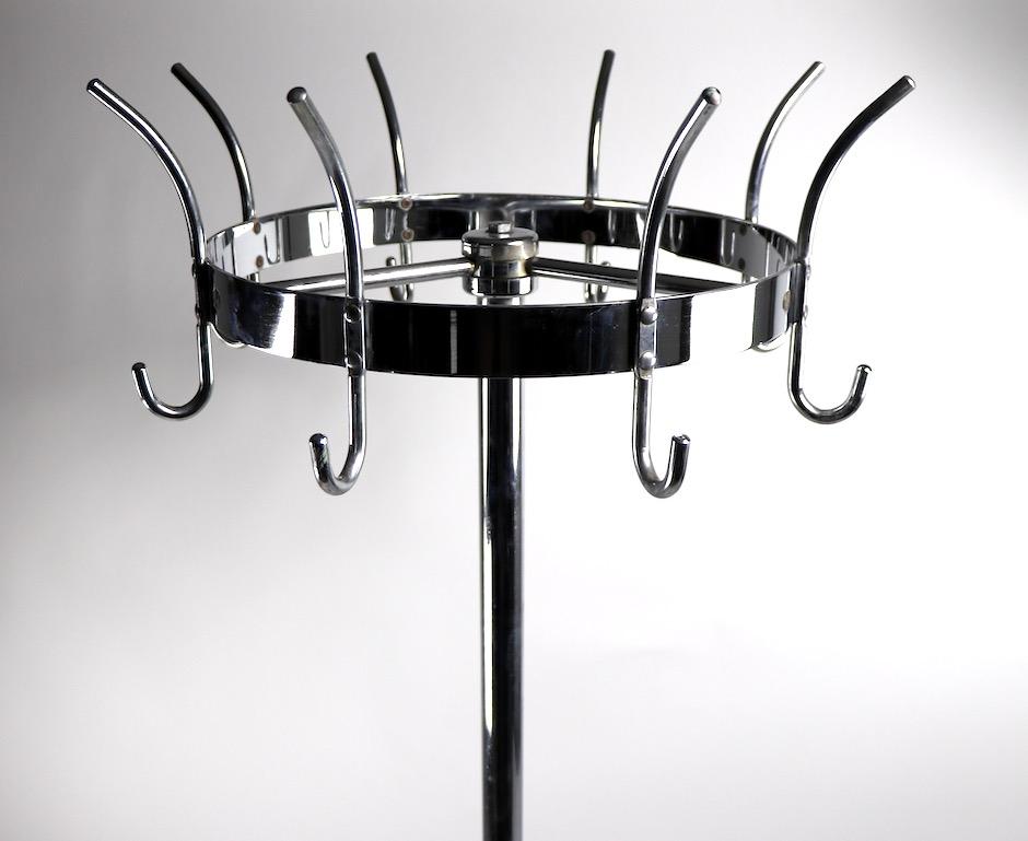 Pure Machine Age style coat, hat rack Stand manufactured by Royalchrome, a division of the Royal Metal Manufacturing Company. This impressive coat tree has a revolving top, having 8 hooks each with a top and bottom hook, for your coat and hat. As