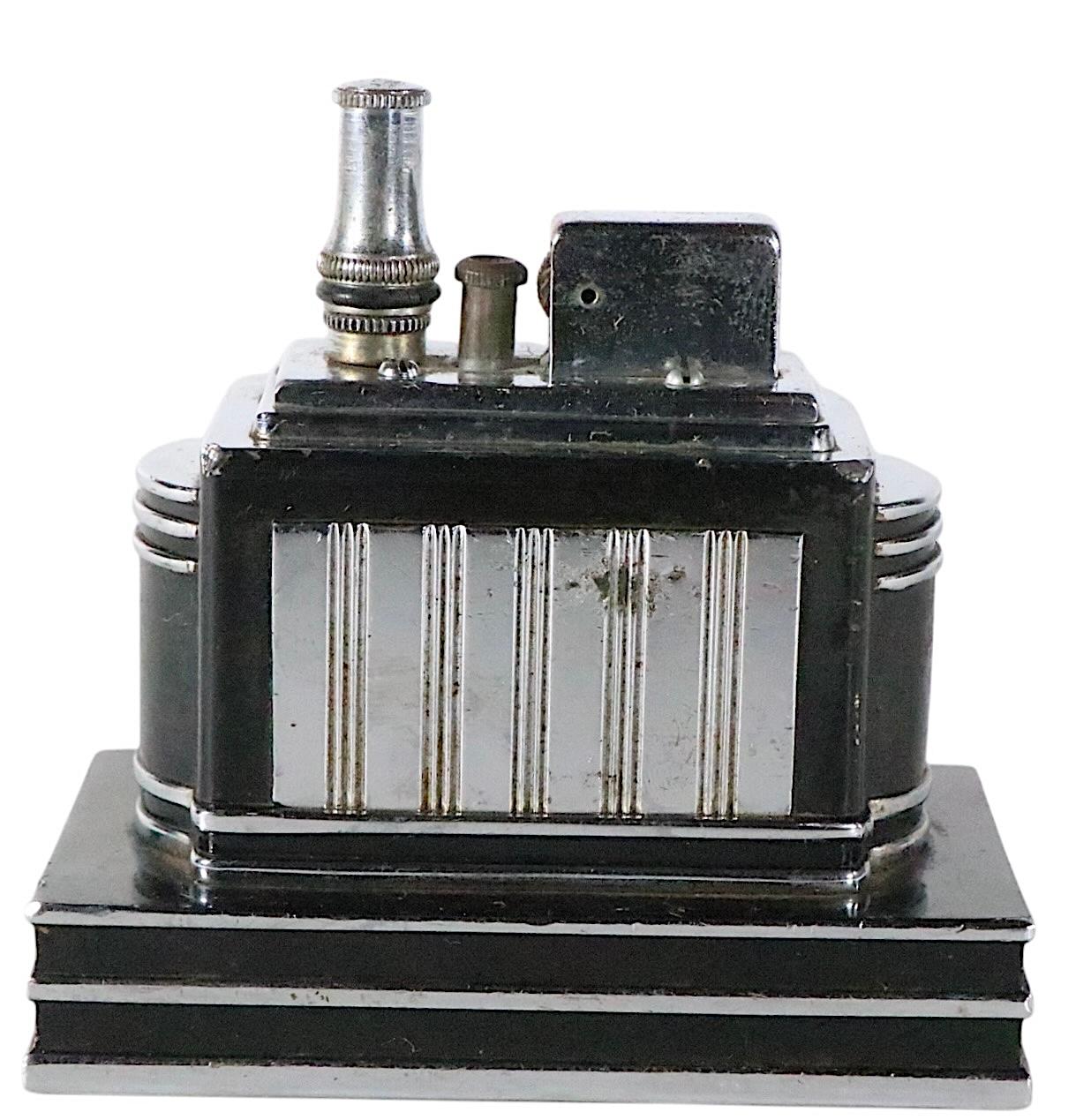 Classic Art Deco Machine Age table top cigarette lighter, by Ronson. This rare model was designed by Louis Vincent  Aronson, made by Ronson Art Metal Works Inc.. Known as a Touch Tip style lighter, this piece has become an icon of the early