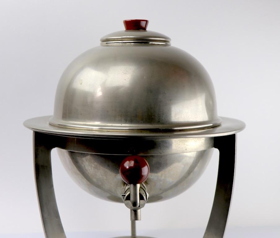 Impressive commercial grade orb form Samovar manufactured by Sterno (marked on base). Constructed of nickeled brass, or bronze, orb form body rests on tri pod base, with space on the bottom for the actual Sterno can if you care to keep your coffee