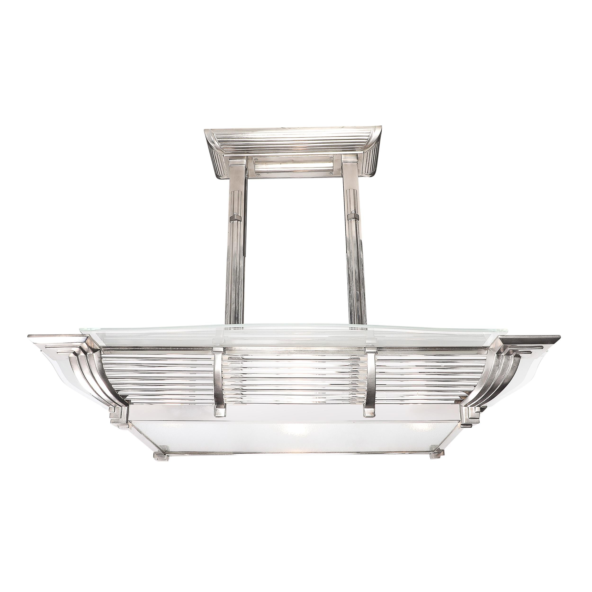 A stunning exemplar of Art Deco elegance and Machine Age innovation, this rectilinear pendant chandelier by Petitot, crafted in France circa 1935, encapsulates the harmonious marriage of form and function so celebrated in its era. With a stringent