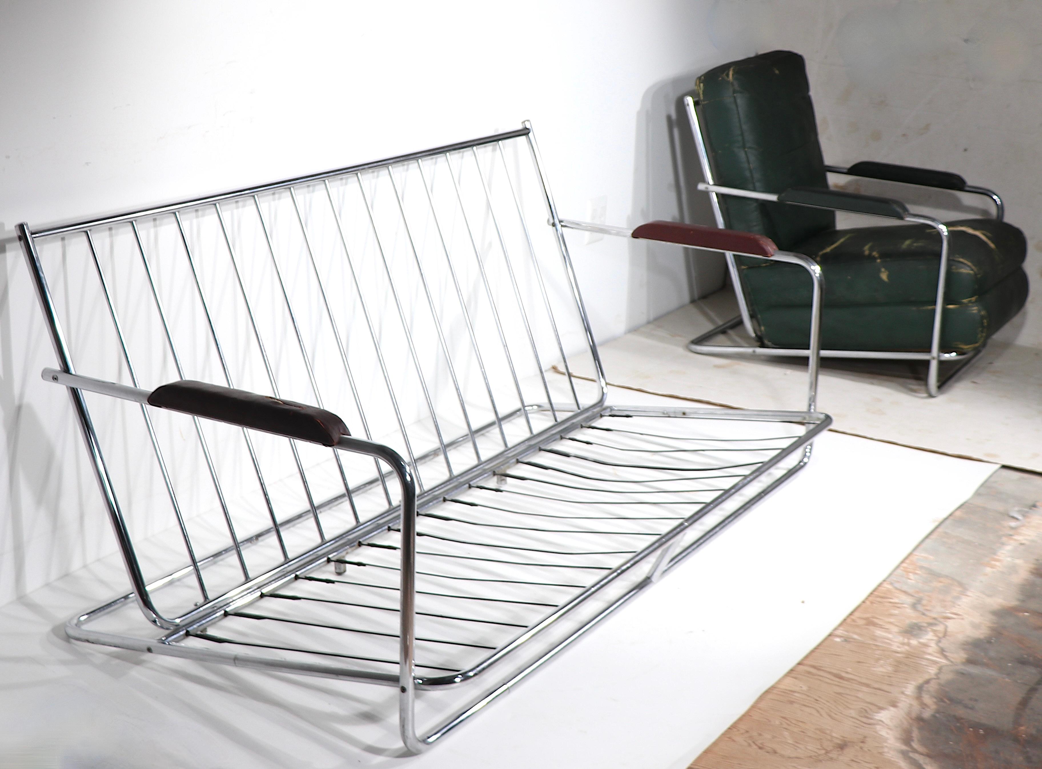 Iconic Art Deco Machine Age sofa designed by Gilbert Rohde for the Troy Sunshade Company, circa 1930's. The couch features a sexy tubular chrome frame, with thick cushions. This classic design still looks modern and relevant almost 100 years after