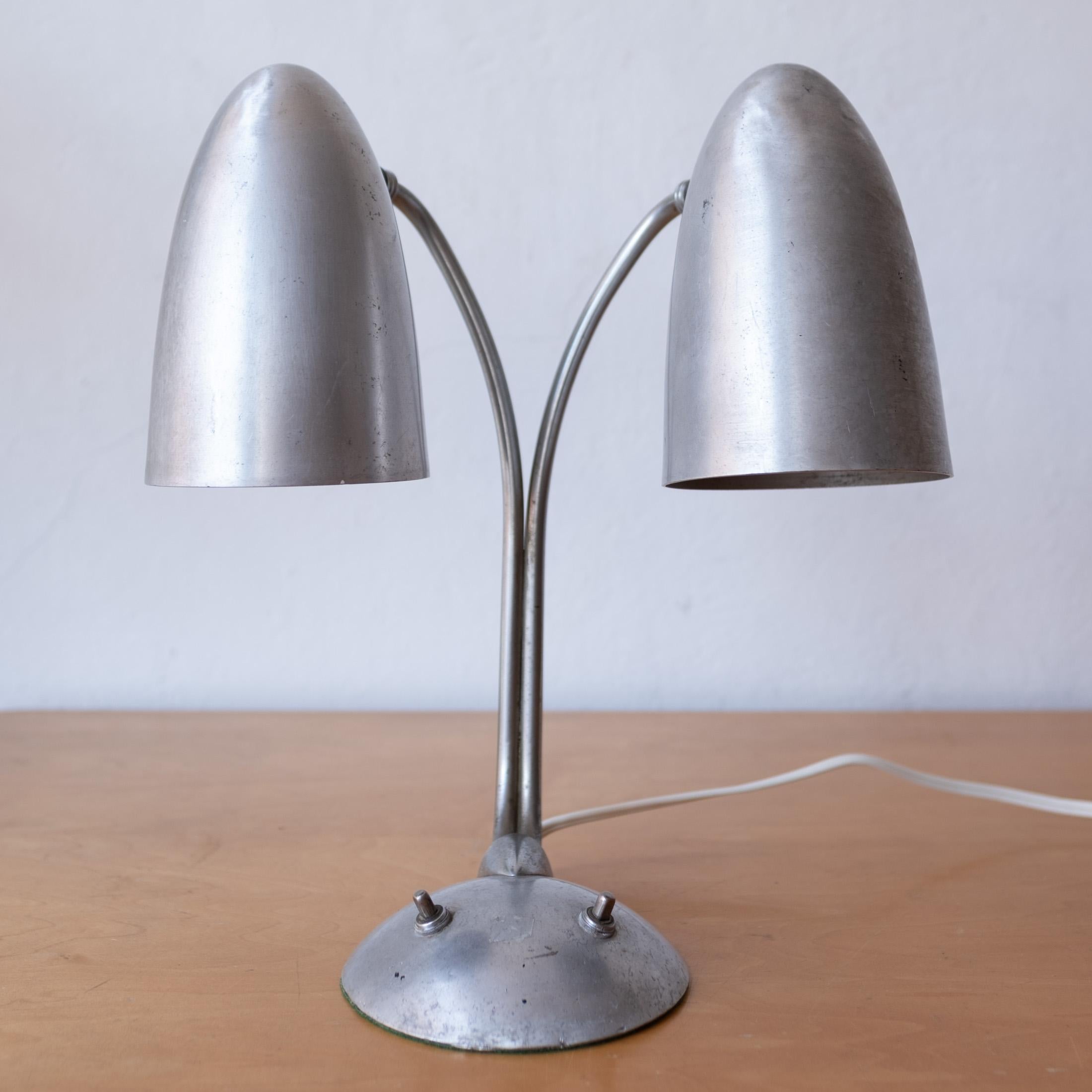 Machine age adjustable spun aluminum desk lamp. Fully articulating two bullet shades. Professionally rewired. Great patina. 1940s