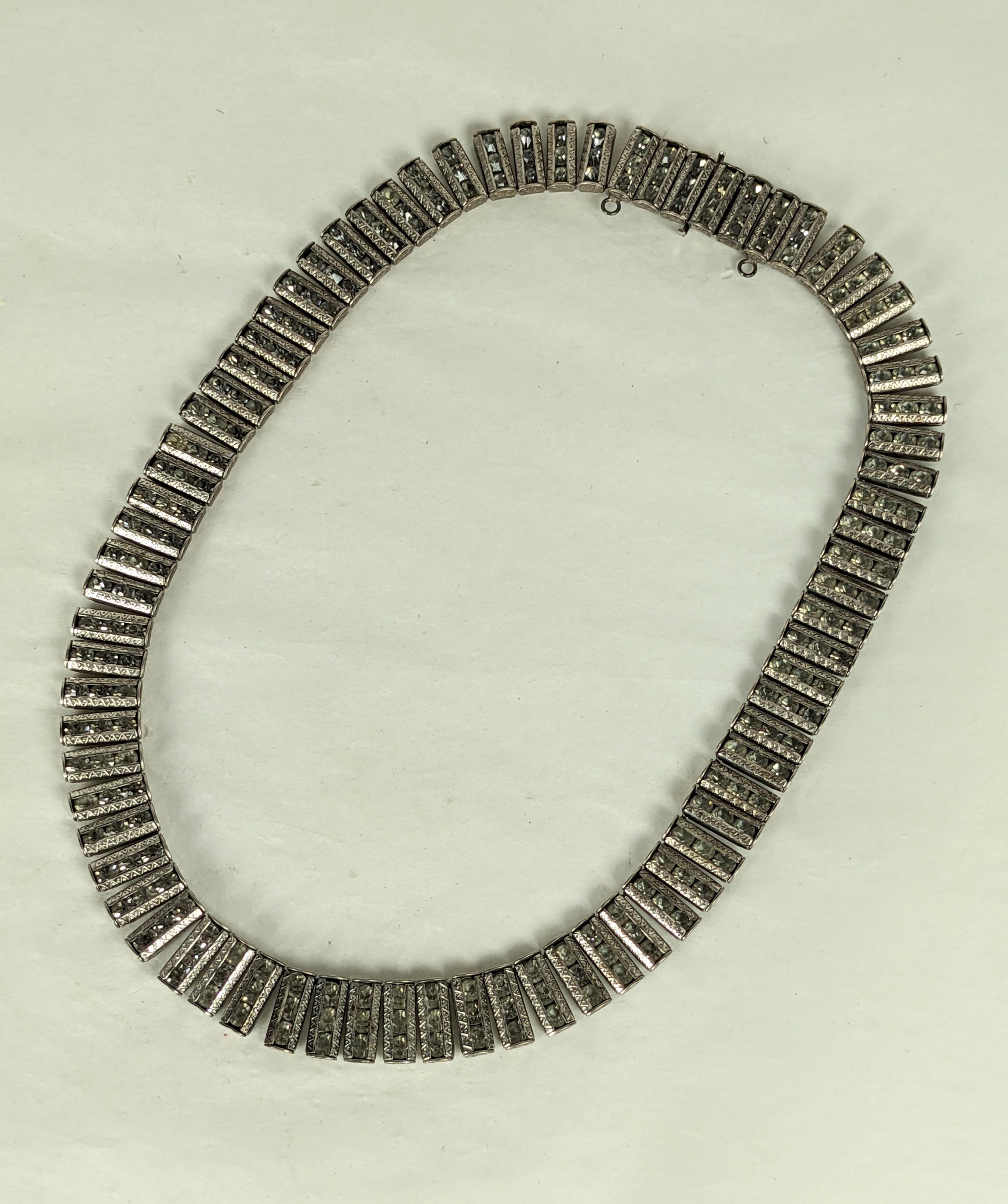 Art Deco Machine Age Sterling articulated necklace of channel set round crystal paste pave links set in rhodium plate sterling silver. Each incised with geometric art deco designs. Clasp closure with safety. 
Excellent Condition. 1920's USA. Signed