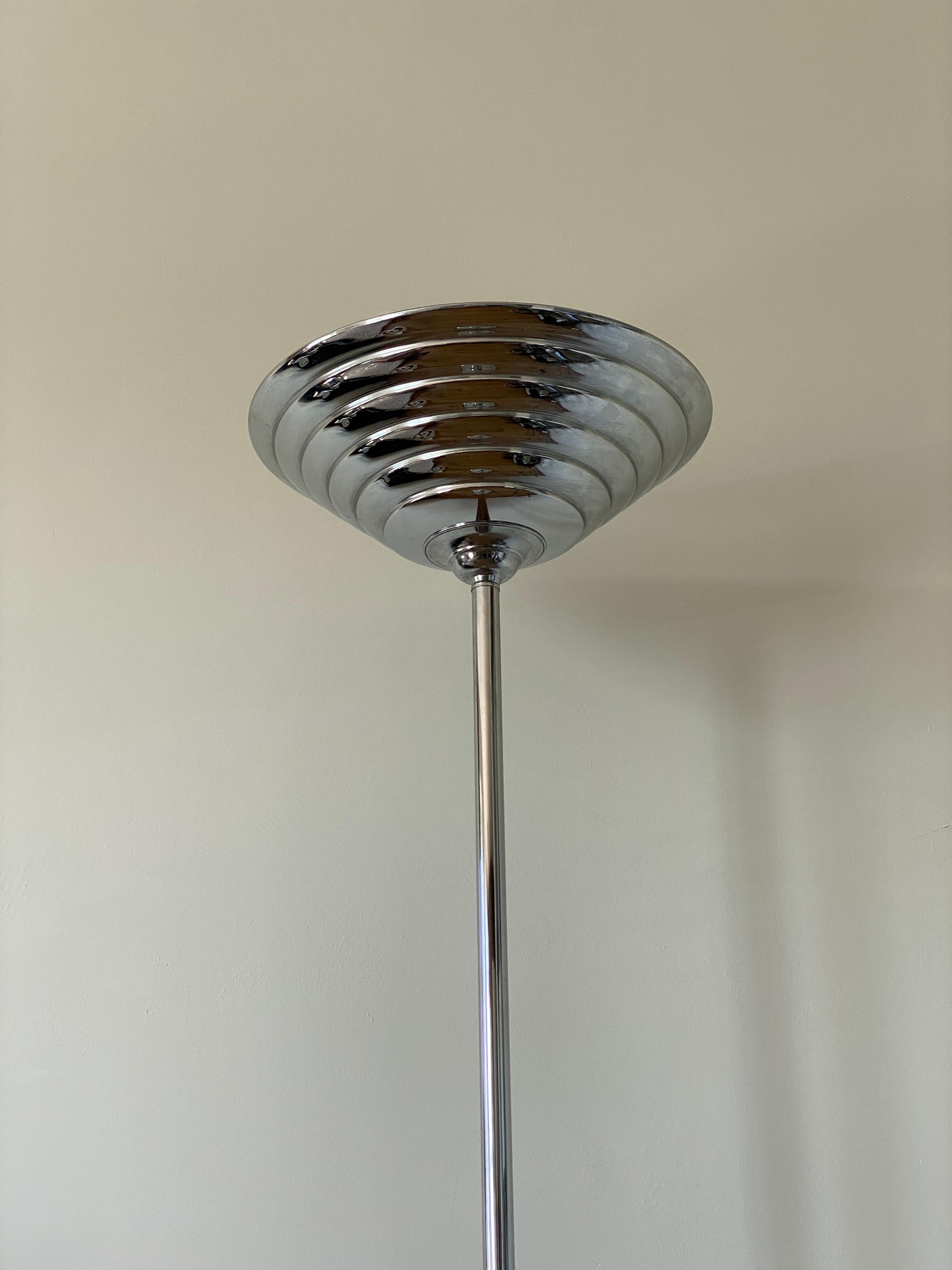Wonderful European Chromed uplighter, floor lamp in Art Deco / Machine Age style. The lamp which was manufactured circa 1980s remains in a very nice condition.