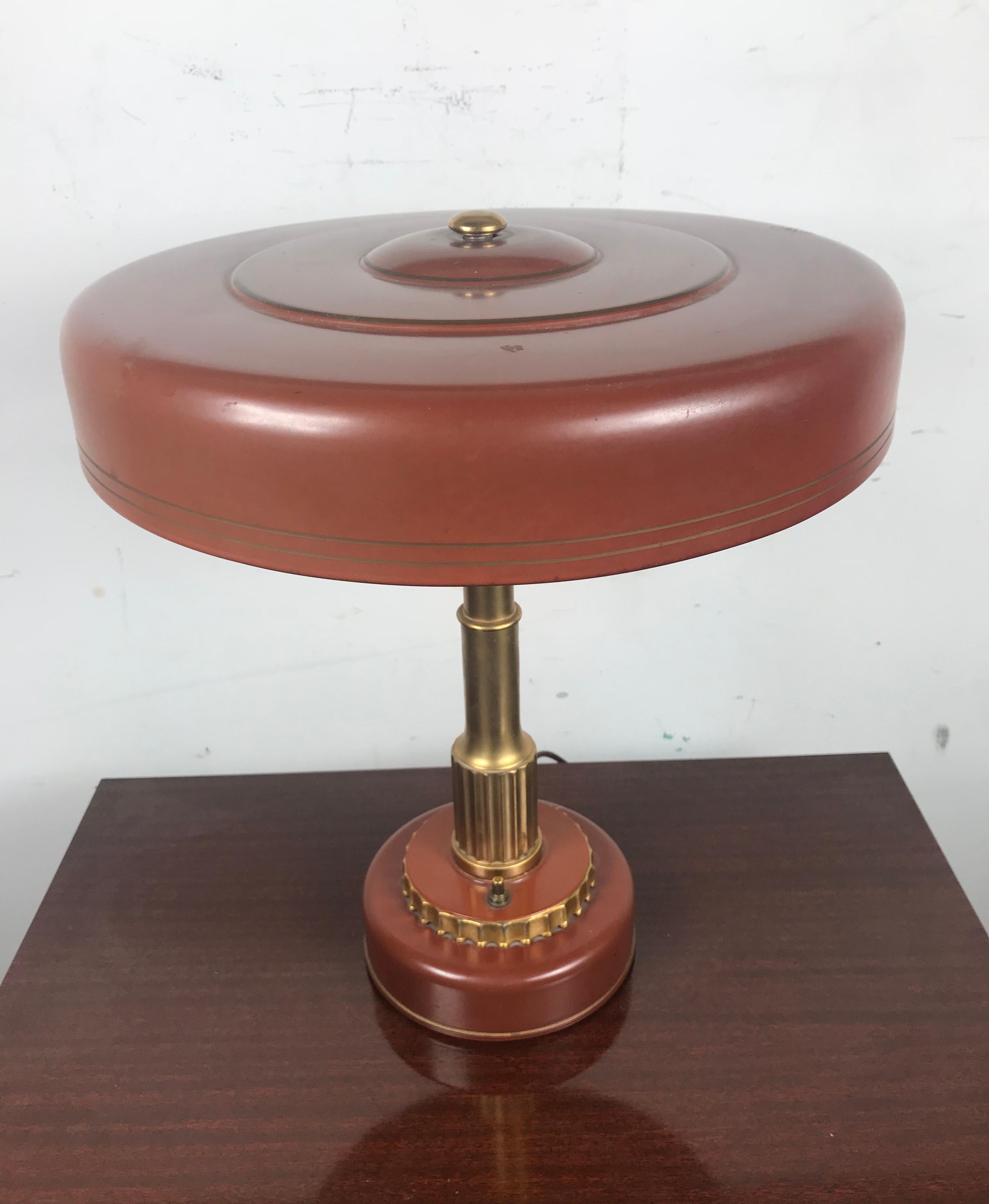 Art Deco Machine age table or desk lamp attributed to Gilbert Rohde for Mutual Sunset Lamp Co., circa 1930s, wonderful original finish, painted metal and brass, push on /off button with florescent lighting. Tested and all electrical working.