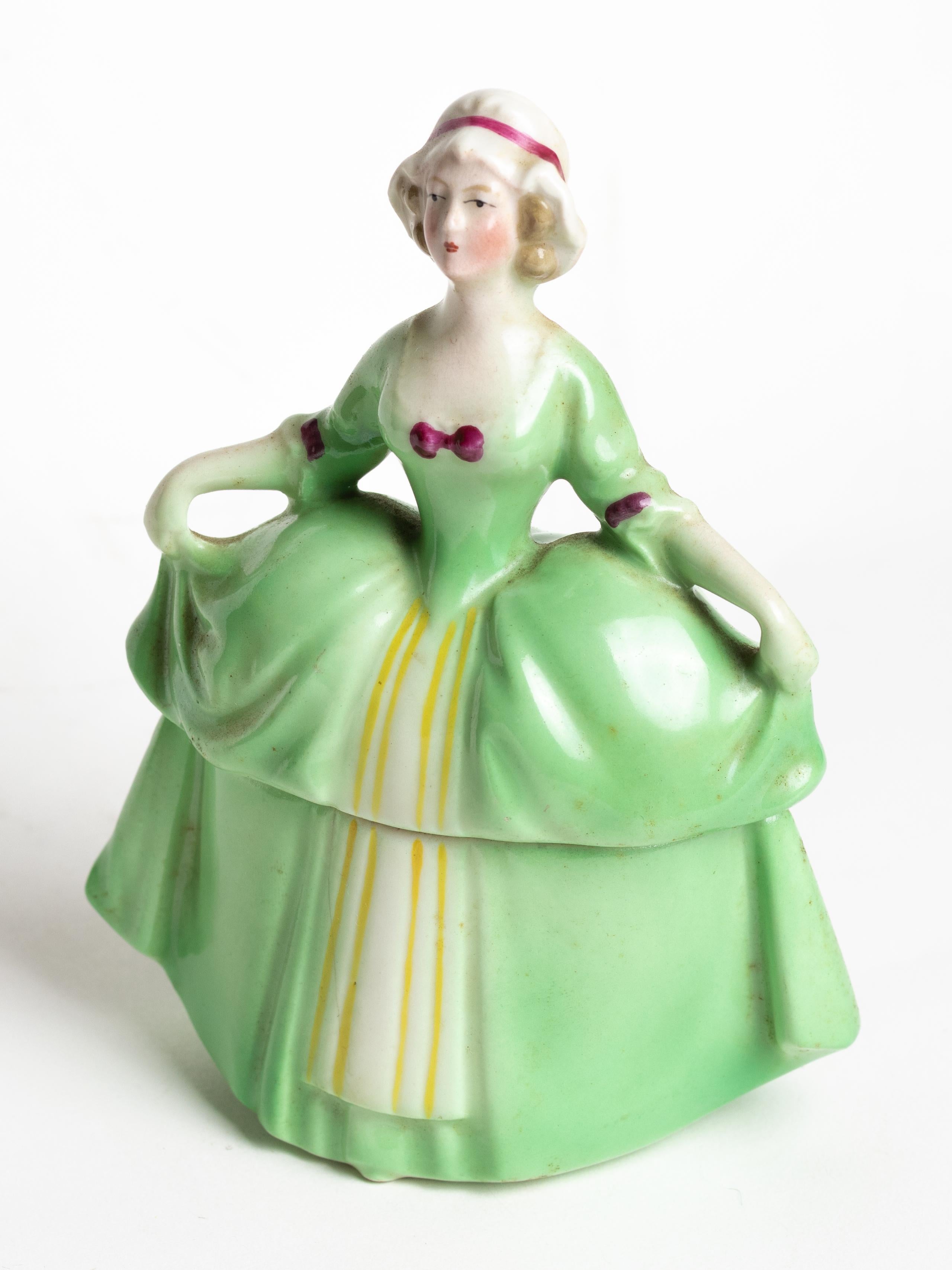 A Madame Pompadour E&R ceramic green dresser doll powder box or trinket box.
A Jewelry holder for vanity accessories or souvenirs.
Made in Bavaria by Schumann Arzberg Germany
Golden Crown E&R. 
