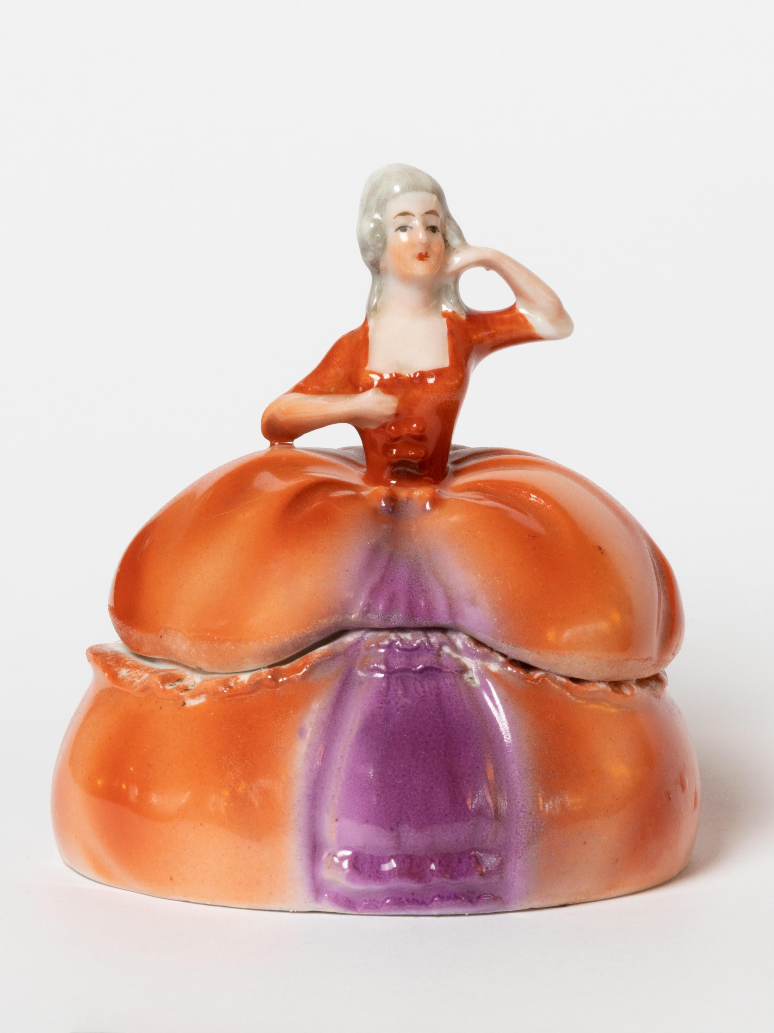A Madame Pompadour E&R ceramic dresser doll powder box or trinket box.
A Jewelry holder for vanity accessories or souvenirs
Made in Bavaria by Schumann Arzberg Germany Golden Crown E&R. 
