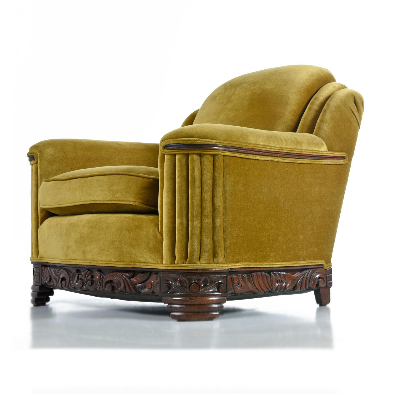 The soft and sensuous gold bronze mohair is in absolutely outstanding condition. Rippled waterfall style pleated tailoring is punctuated by the hand carved mahogany base and accents on the arms. One does not have to compromise comfort for style with