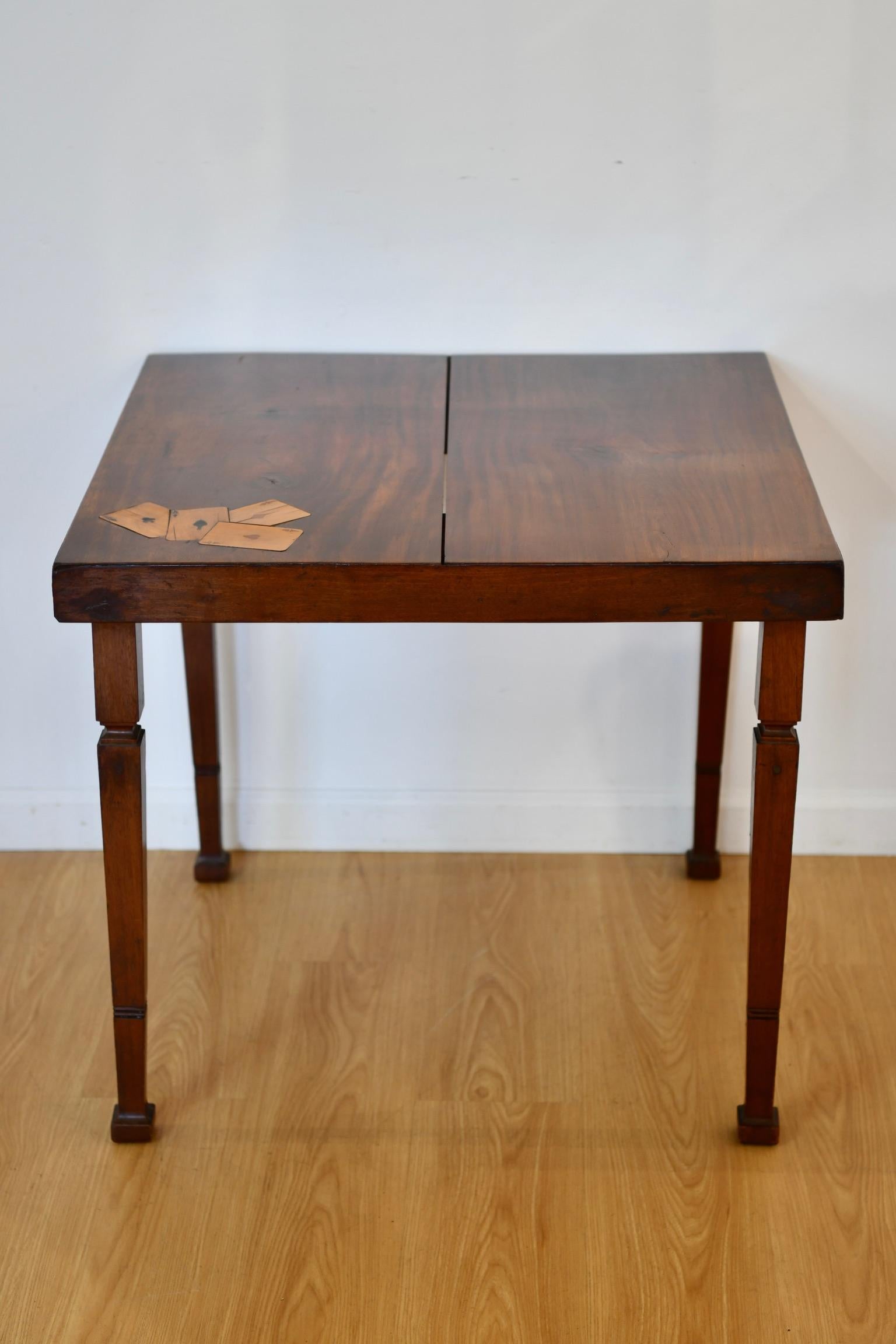 Art Deco mahogany square games table with inlay of four aces playing cards and raised on square tapered legs. Dimensions: 26.5