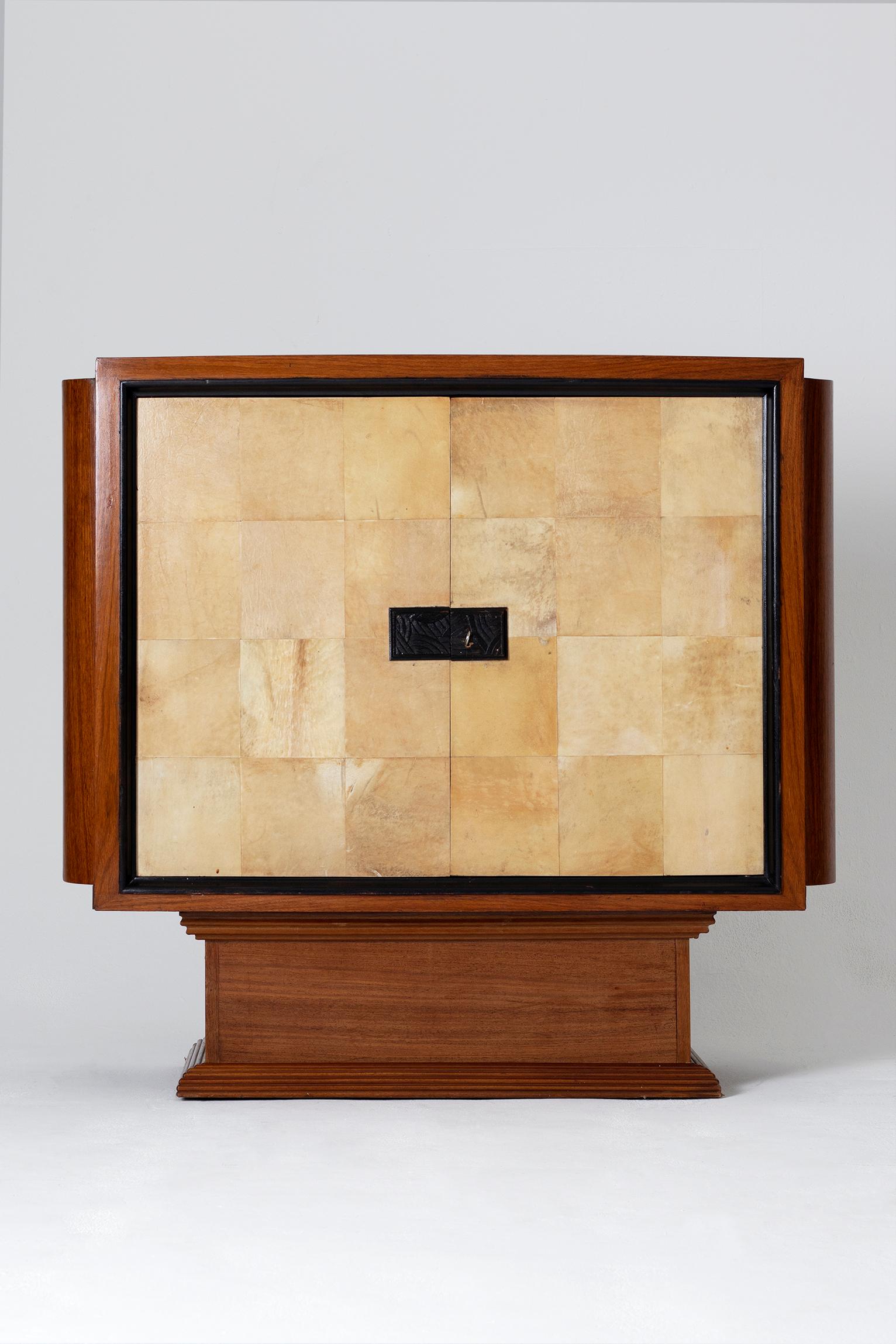 An Art Deco mahogany and velum cabinet,
The two door clad in velum revealing a shelf and a drawers, adorned with geometric marquetry and clad in velum.
France, circa 1930.