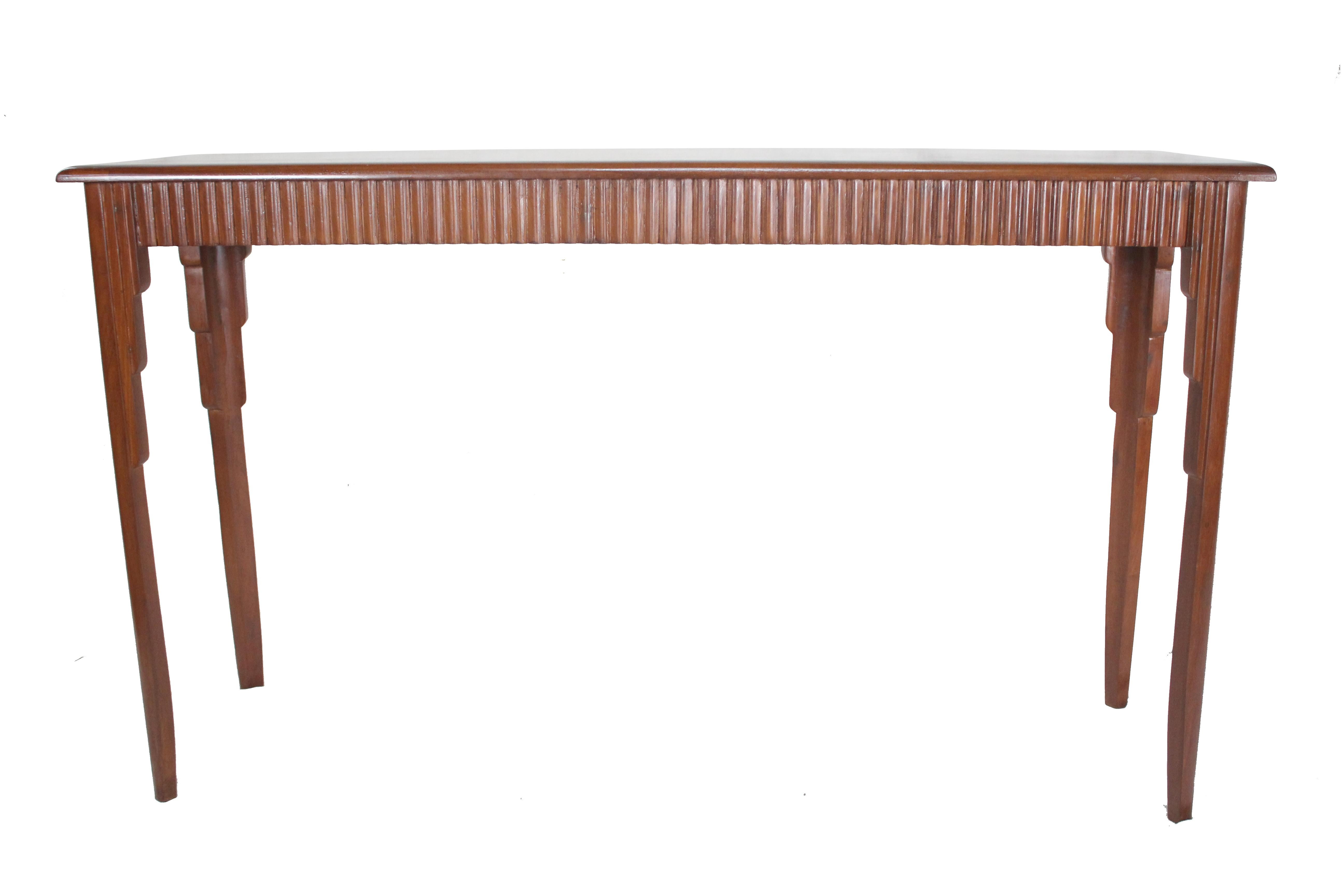 An Art Deco mahogany console or sofa table. Reeded on all four sides with a beveled-edge top, and architecturally beveled and stepped tapered legs. European. Multi functional as a behind the sofa table, a serving piece, or console table.