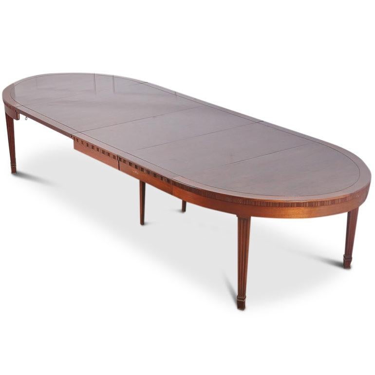 A stunning Art Deco extending mahogany dining table. Lovely banding around the circumference and complete with two sets of secondary support legs, circa 1930. Three large leaves extend the table to over 12 feet. Comfortably seats 12.

67 inches