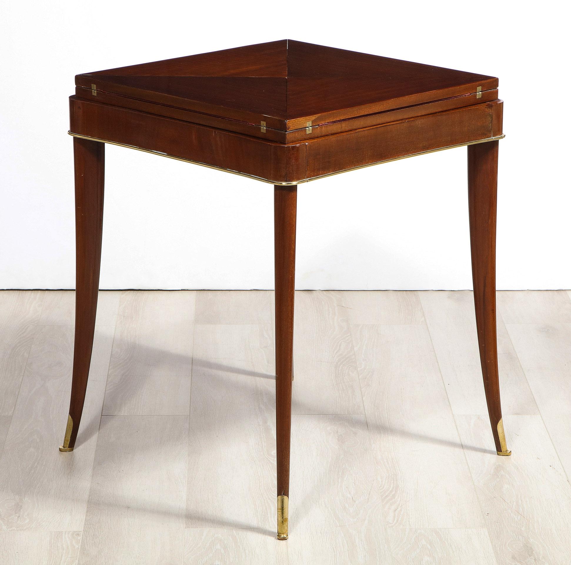 The square hinged handkerchief top rotating open to reveal a felt interior, the shaped frieze with one drawer, the whole with ormolu-mounts.

Closed the table is 24