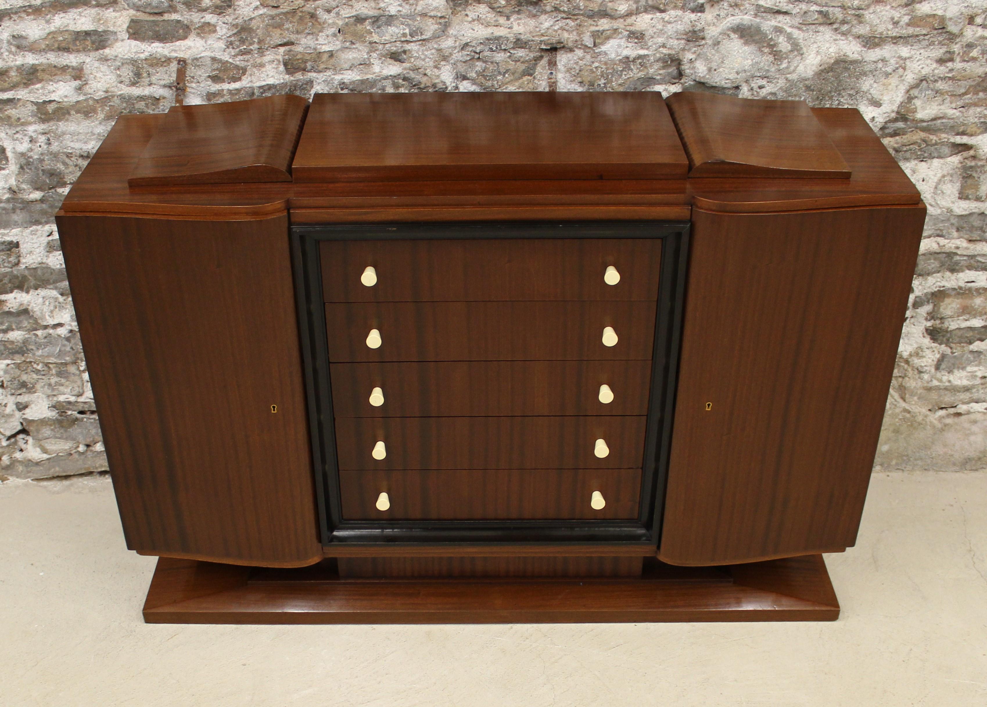 Art Deco Mahogany sideboard with double bowed doors flanking five drawers with turned natural handles surrounded by an ebonized stepped frame.

Credenza / Sideboard / Buffet / Cabinet.