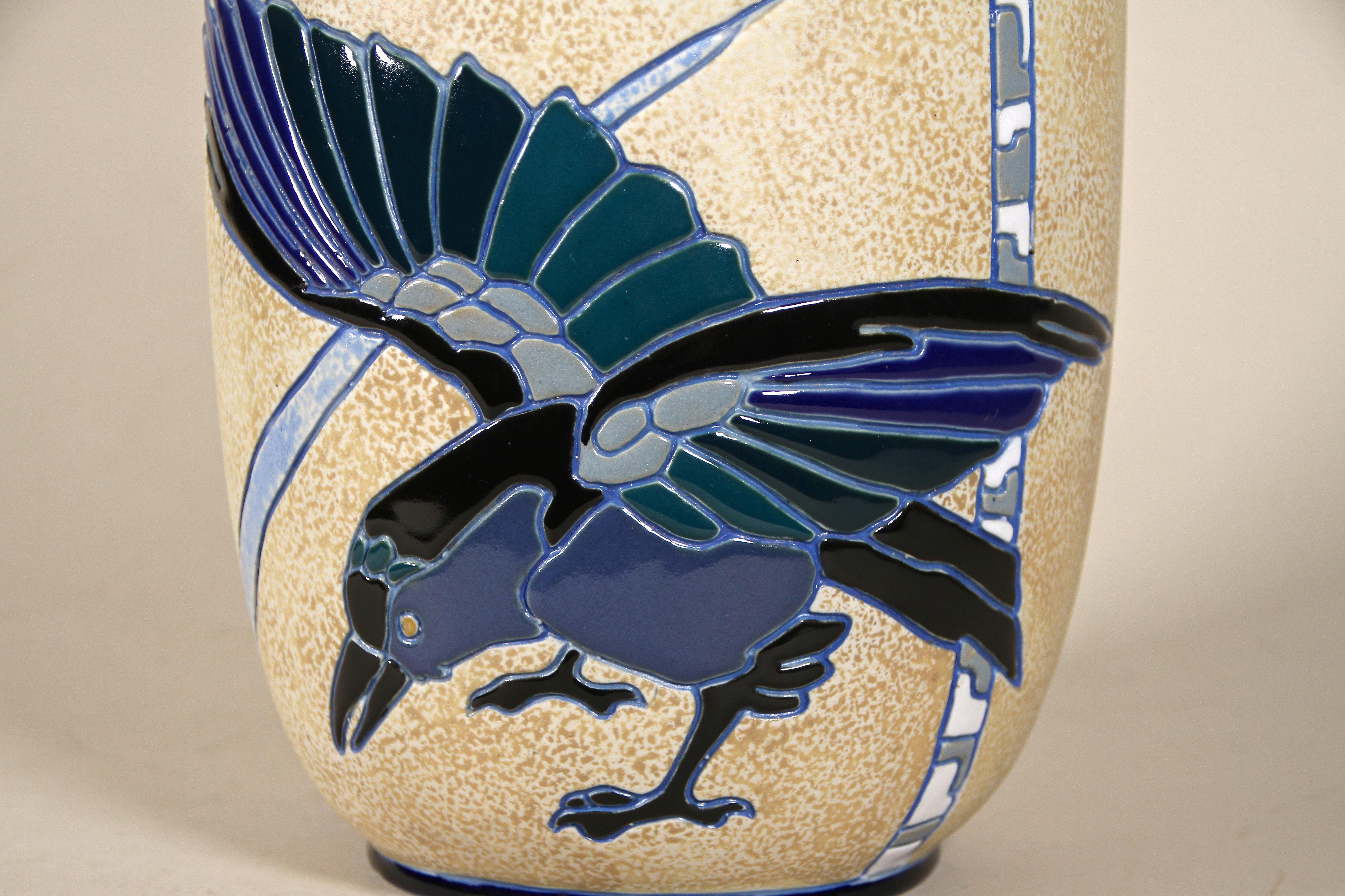 Unique Art Nouveau Majolica Vase by Amphora Czechoslovakia from the early Art Deco period around 1920. The beautiful shaped body shows a fantastic relief design with unusual polychrome enameled raven. A main eyecatcher are definitely the three