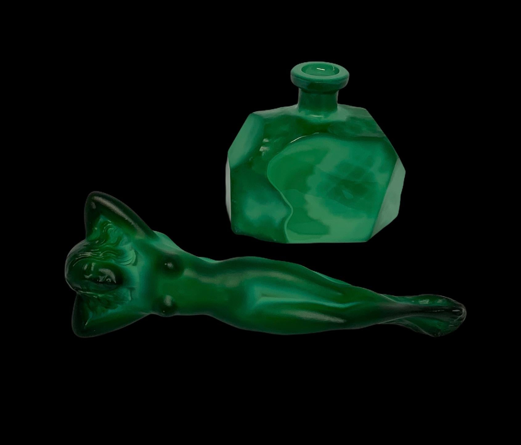A faceted malachite perfume bottle that depicts a lid shaped as a nude lady. The bottle was made using Heinrich Hoffman mold. He is famous for his Lalique’s vases, bottles, and sculptures.