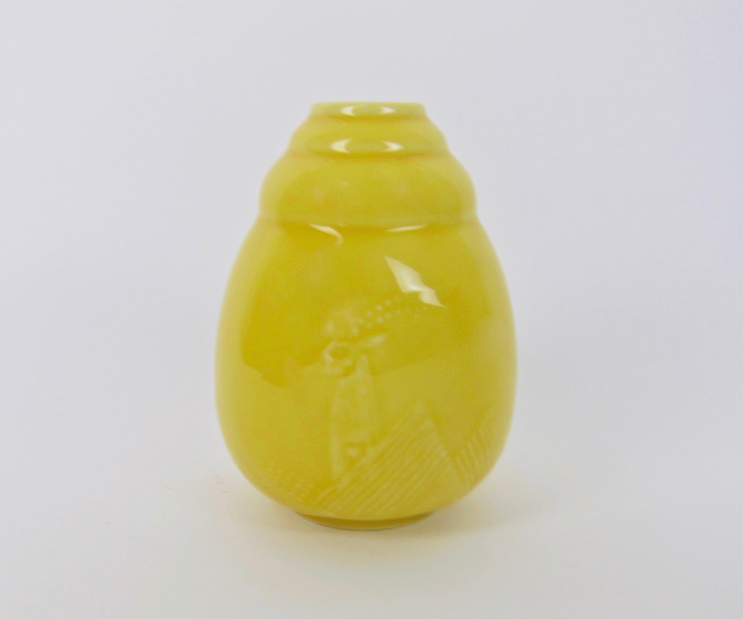 An American Art Deco porcelain vase by Rookwood Pottery designer, William Hentschel (1892-1962), for Kenton Hills Porcelains in the early 1940s. The vintage vase features a sunny Mandarin Yellow glaze over a white porcelain body. The Hentschel decor