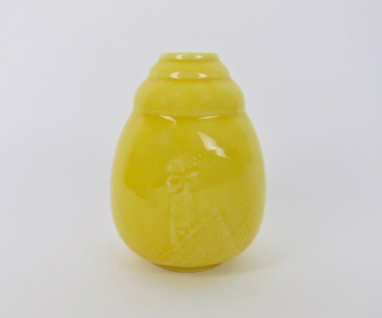 An American Art Deco porcelain vase by Rookwood Pottery designer, William Hentschel (1892-1962), for Kenton Hills Porcelains in the early 1940s. The vintage vase features a sunny Mandarin Yellow glaze over a white porcelain body. The Hentschel decor