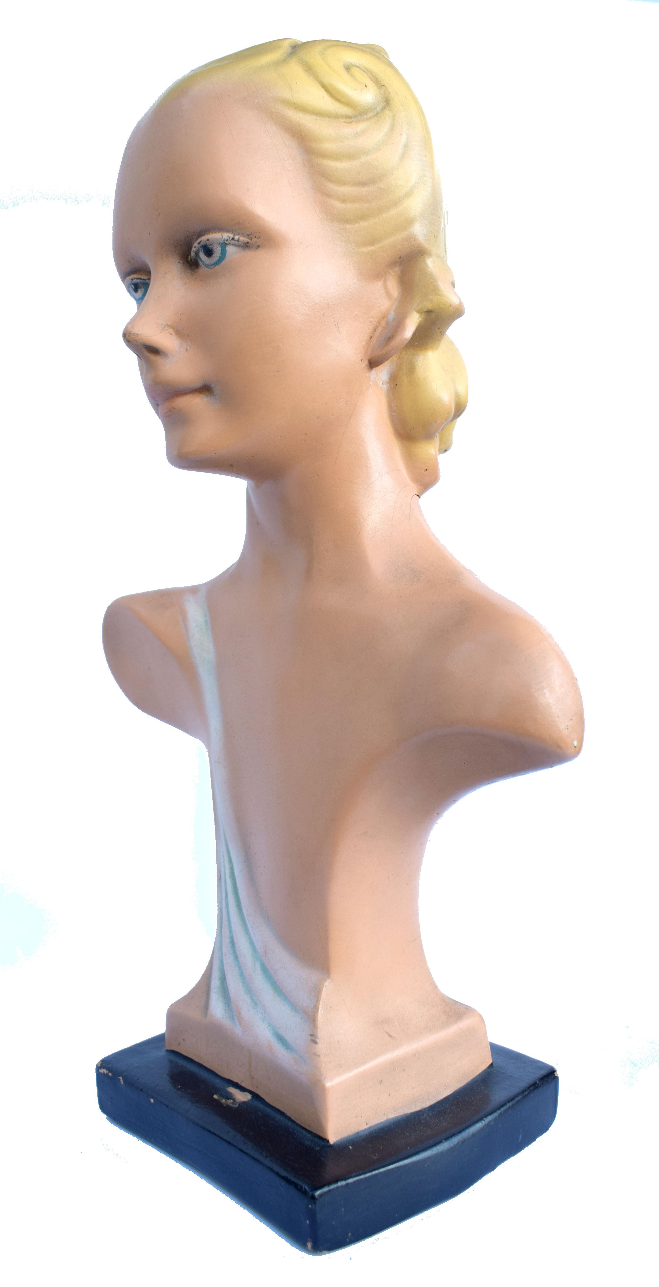 Wonderfully stylish and completely original 1930s Art Deco female mannequin. She's made from compressed board, similar to papier maché and then skillfully layer of plaster and hand painted on top. She's very typical of Deco mannequins with stylized