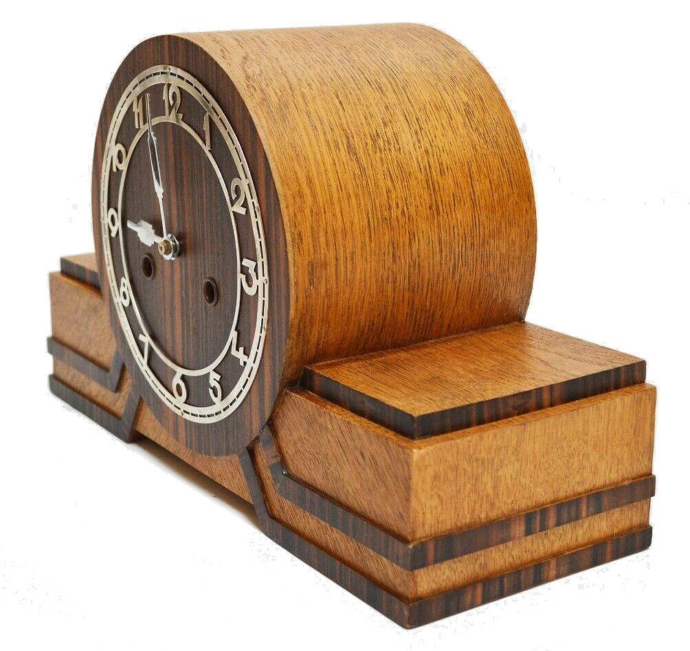For your consideration is this superbly stylish and fully restored German Bauhaus mantel clock manufactured by Junghans in the 1930's. This is a beautifully crafted and seldomly seen art deco table or mantle clock showcasing different types of wood