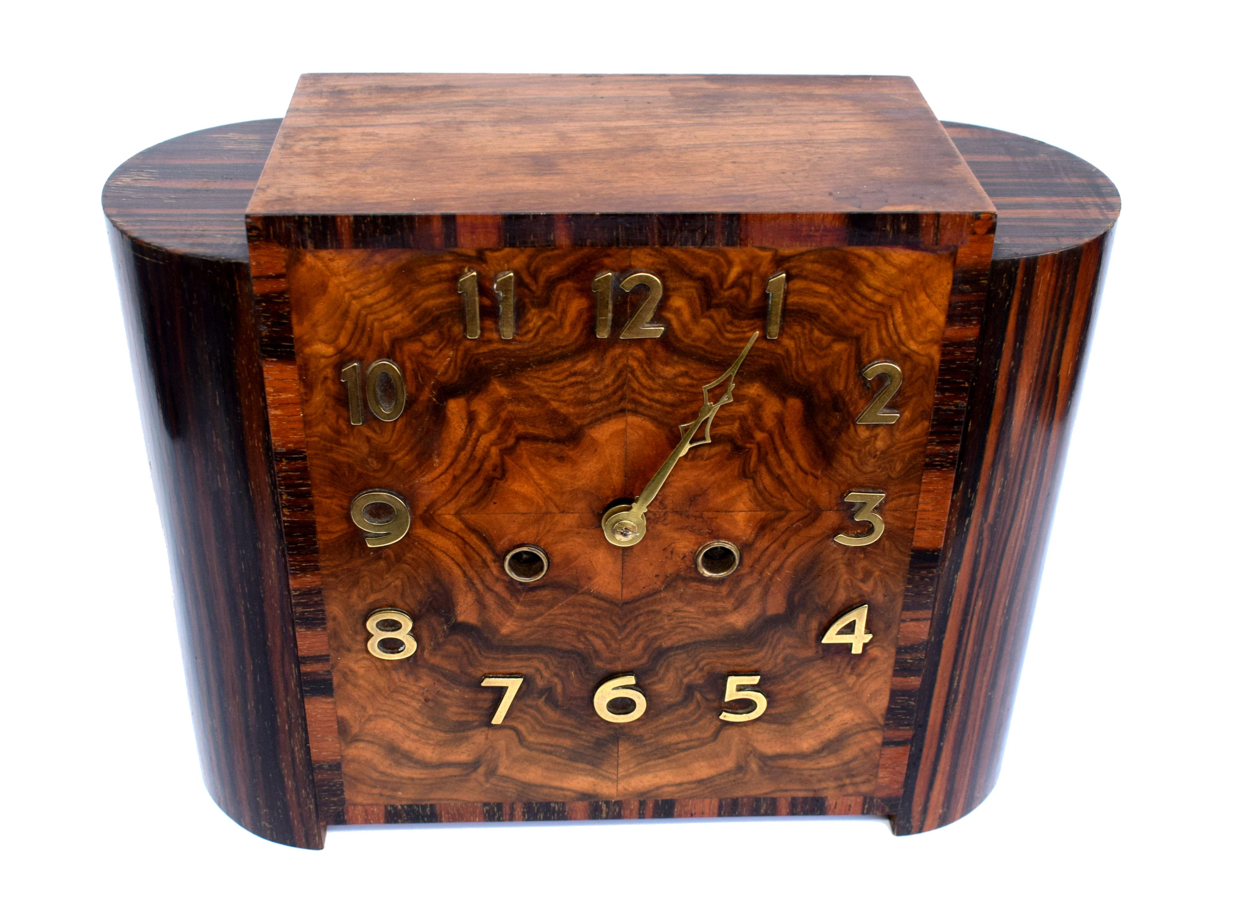 For your consideration is the very good quality and extremely attractive Art Deco mantle clock made in Germany and dating to the 1930s. The casing is the real hero of this timepiece, great size with heavily figured walnut veneered dial with Ebony