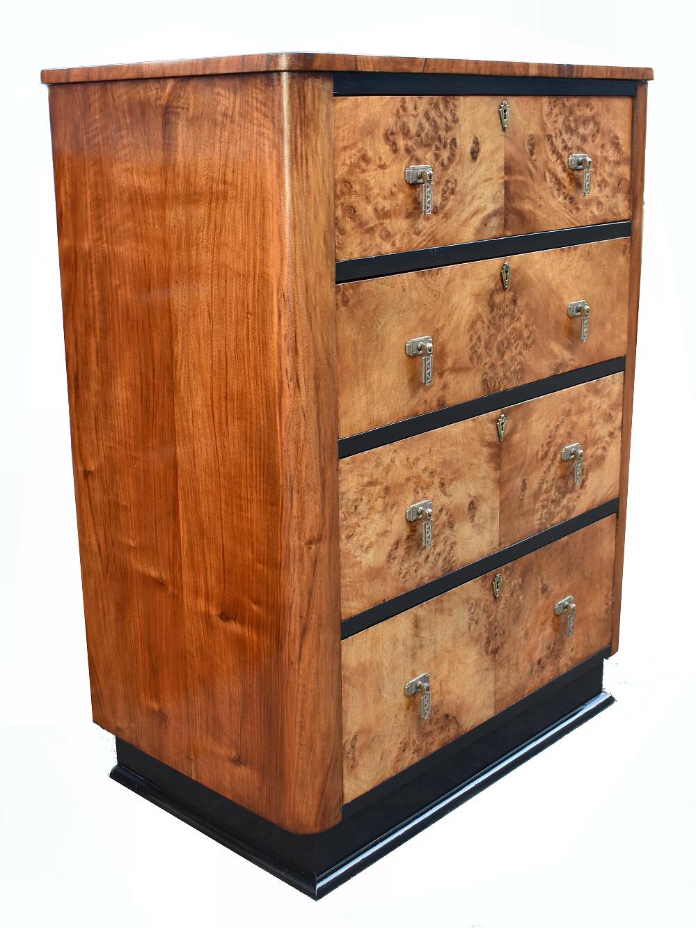 For your consideration is this very stylish and original Art Deco chest of drawers which dates to late 1920s-early 1930s. Resting on an ebonized plinth are four generously sized drawers which are veneered in blonde bird's-eye maple. Each drawer