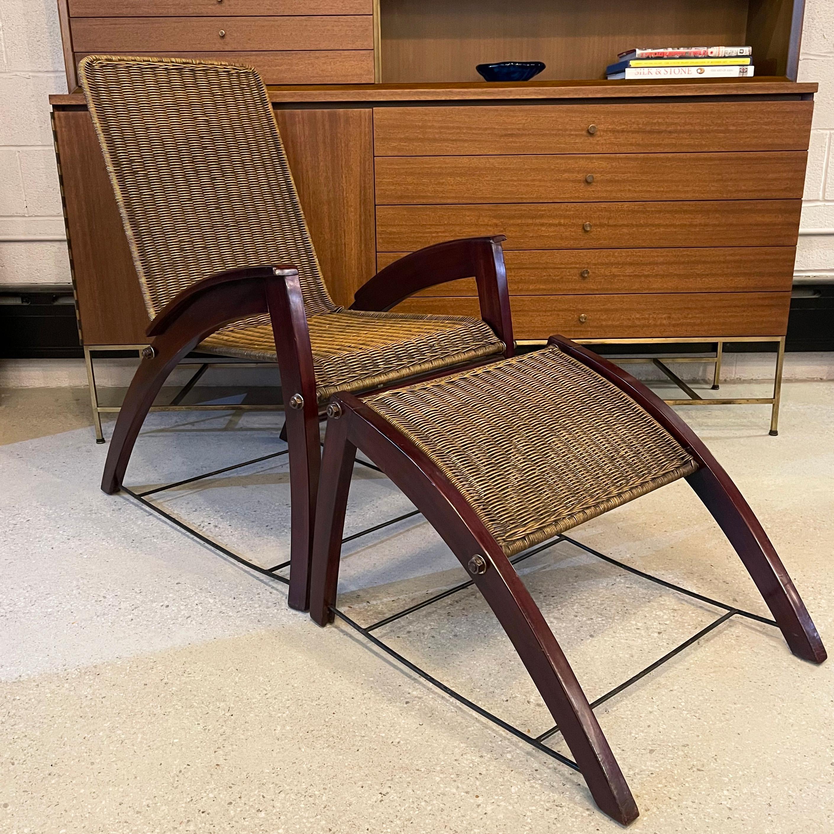 Handsome, art deco, lounge chair and ottoman set features a dark maple frame with woven wicker backing that forms an accentuated demi-lune shape. The 31 inch deep chair and 25 inch deep ottoman are constructed with metal bracing. The arm height is